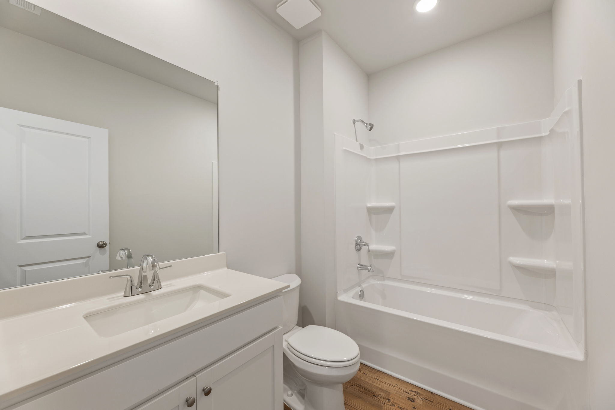 A bathroom with a tub sink and toilet.