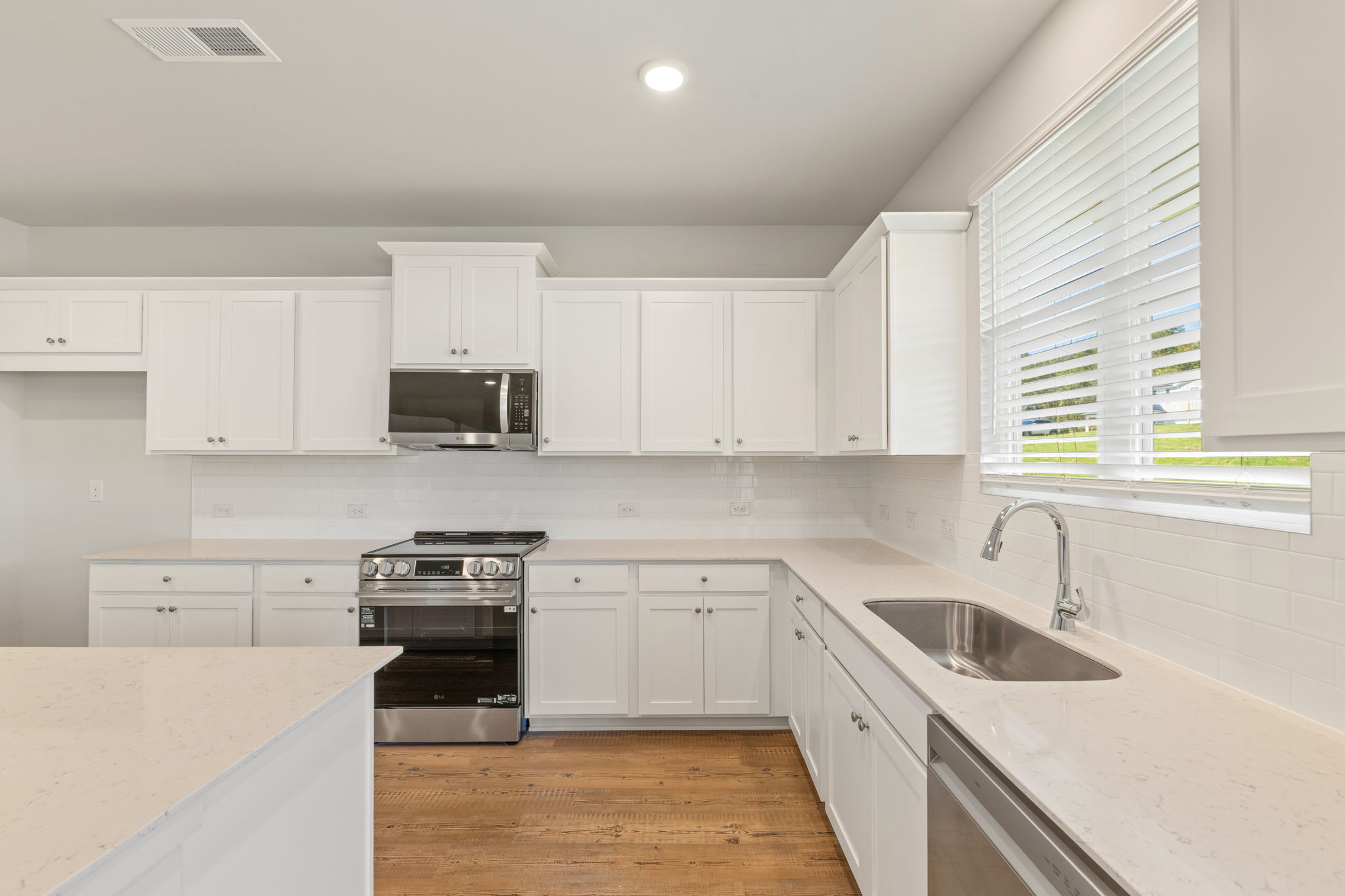 A kitchen with white cabinets.