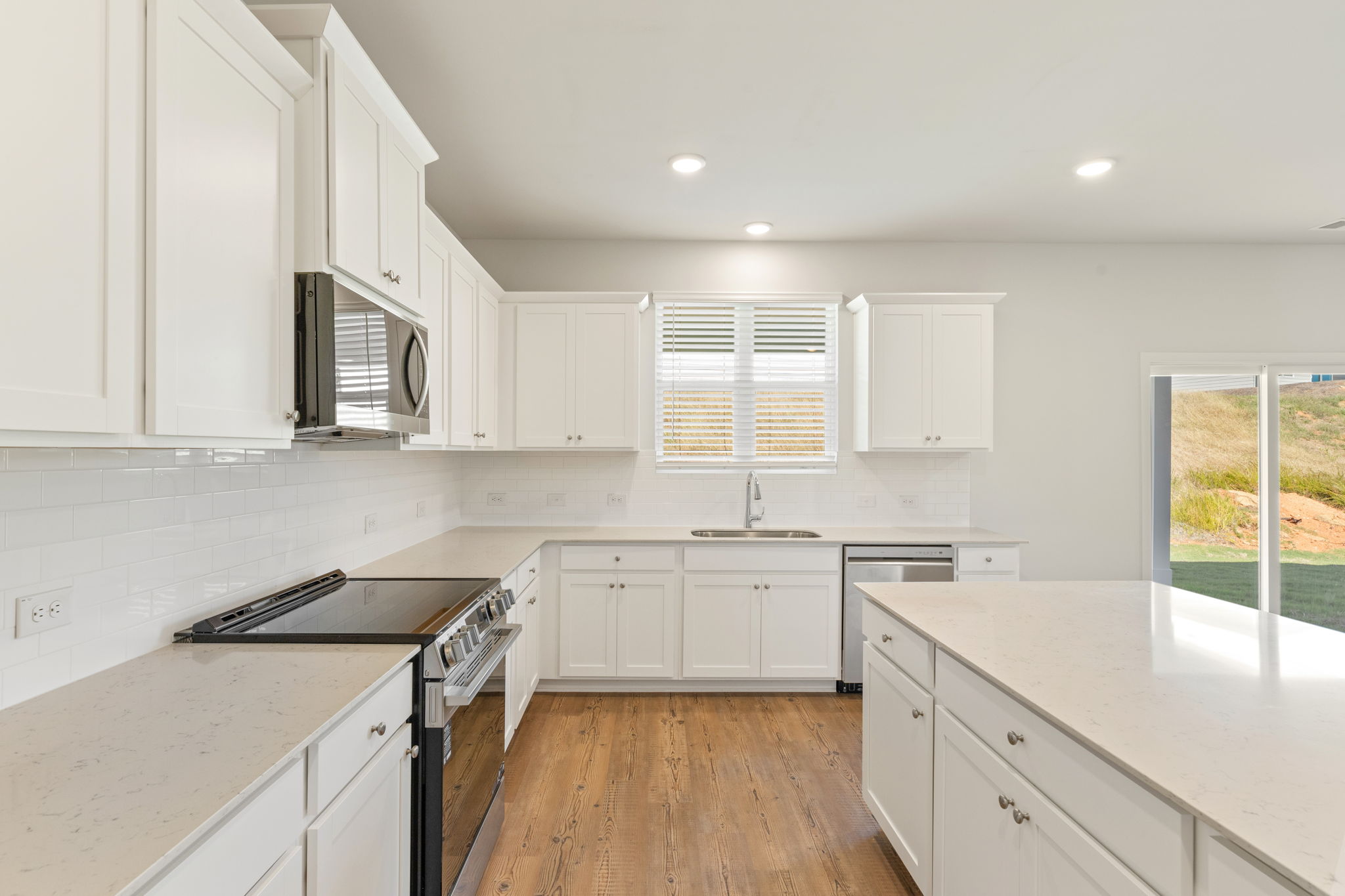 A kitchen with white cabinets.