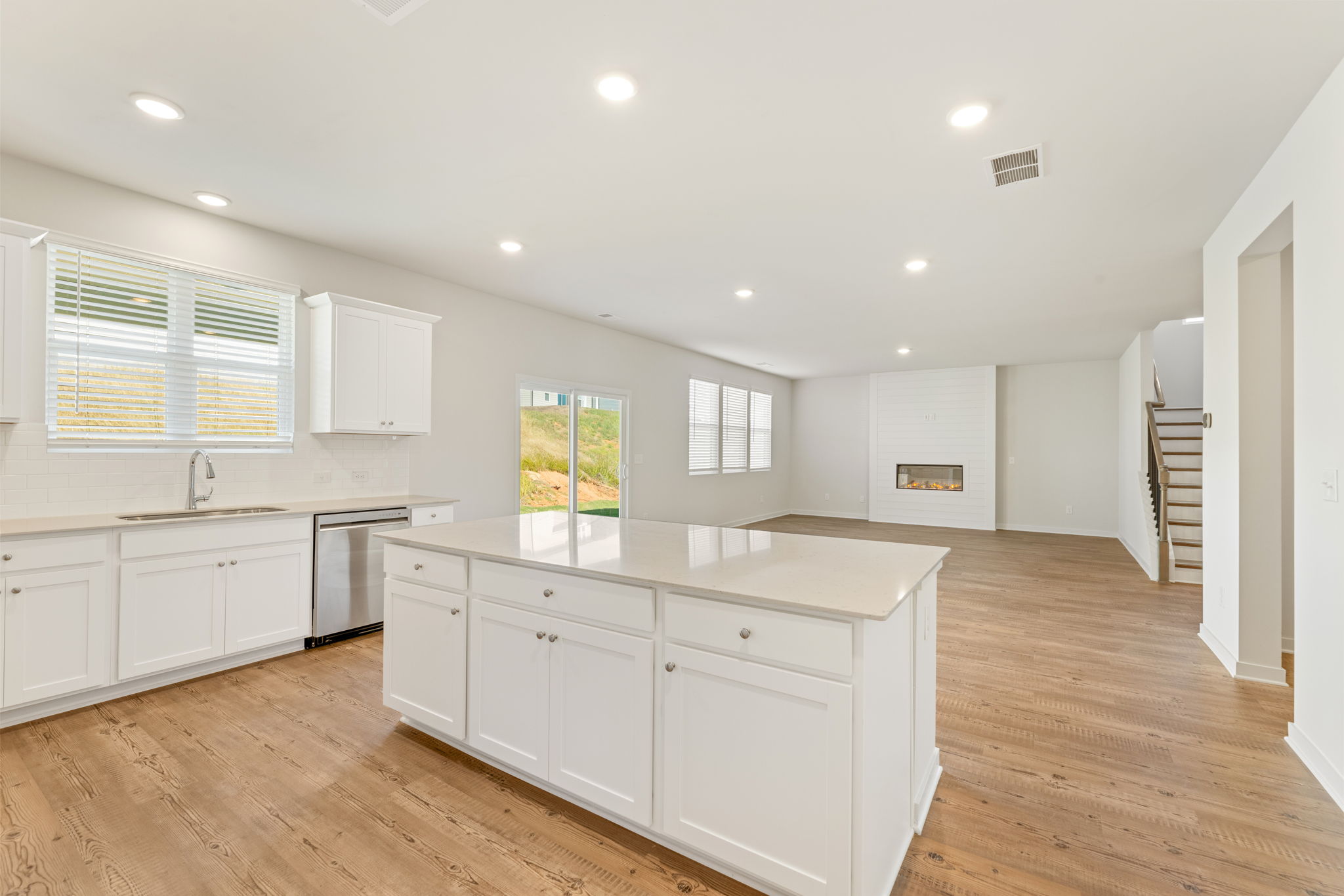 A kitchen with white cabinets.
