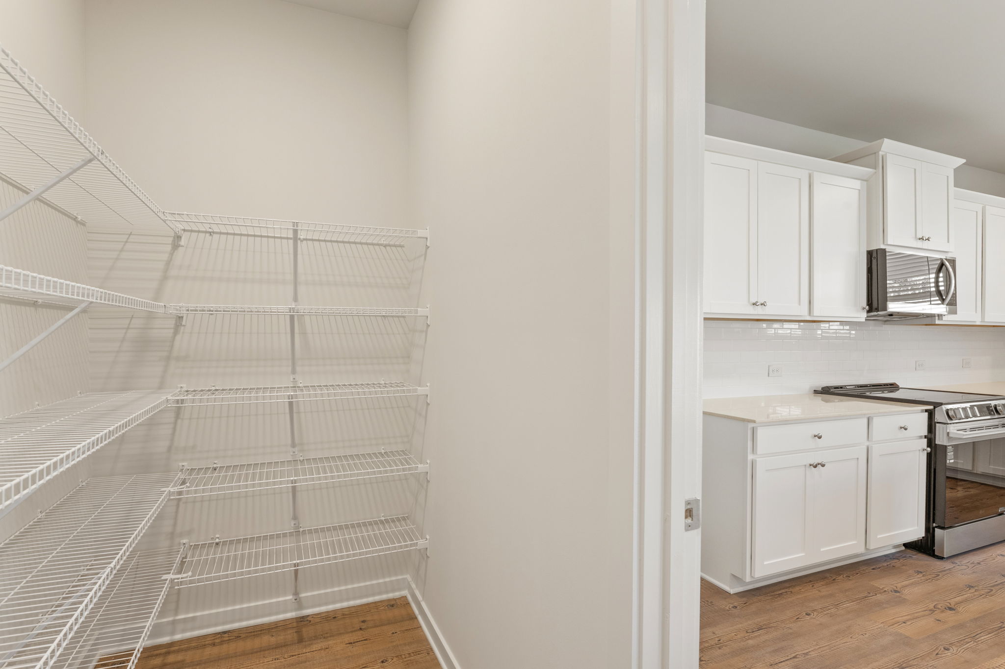 A kitchen with white cabinets.