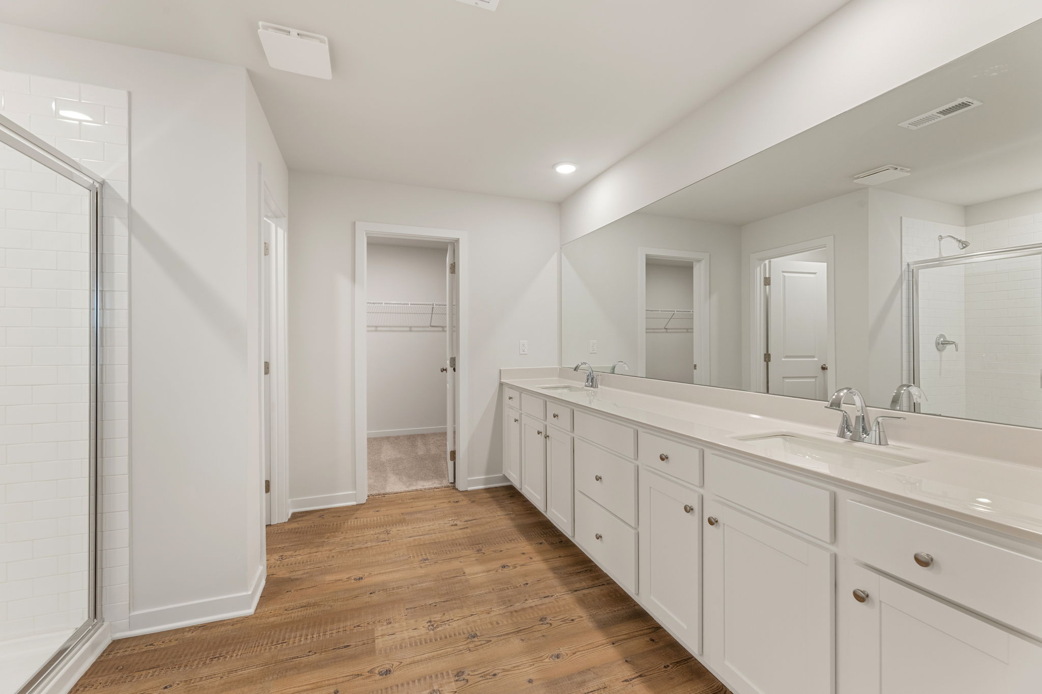 A bathroom with white cabinets.