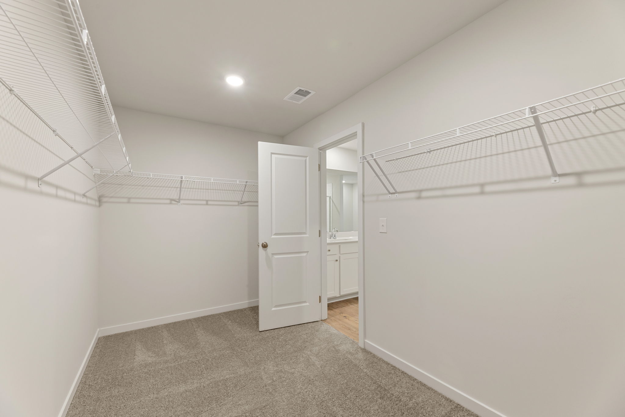 A hallway with white walls.