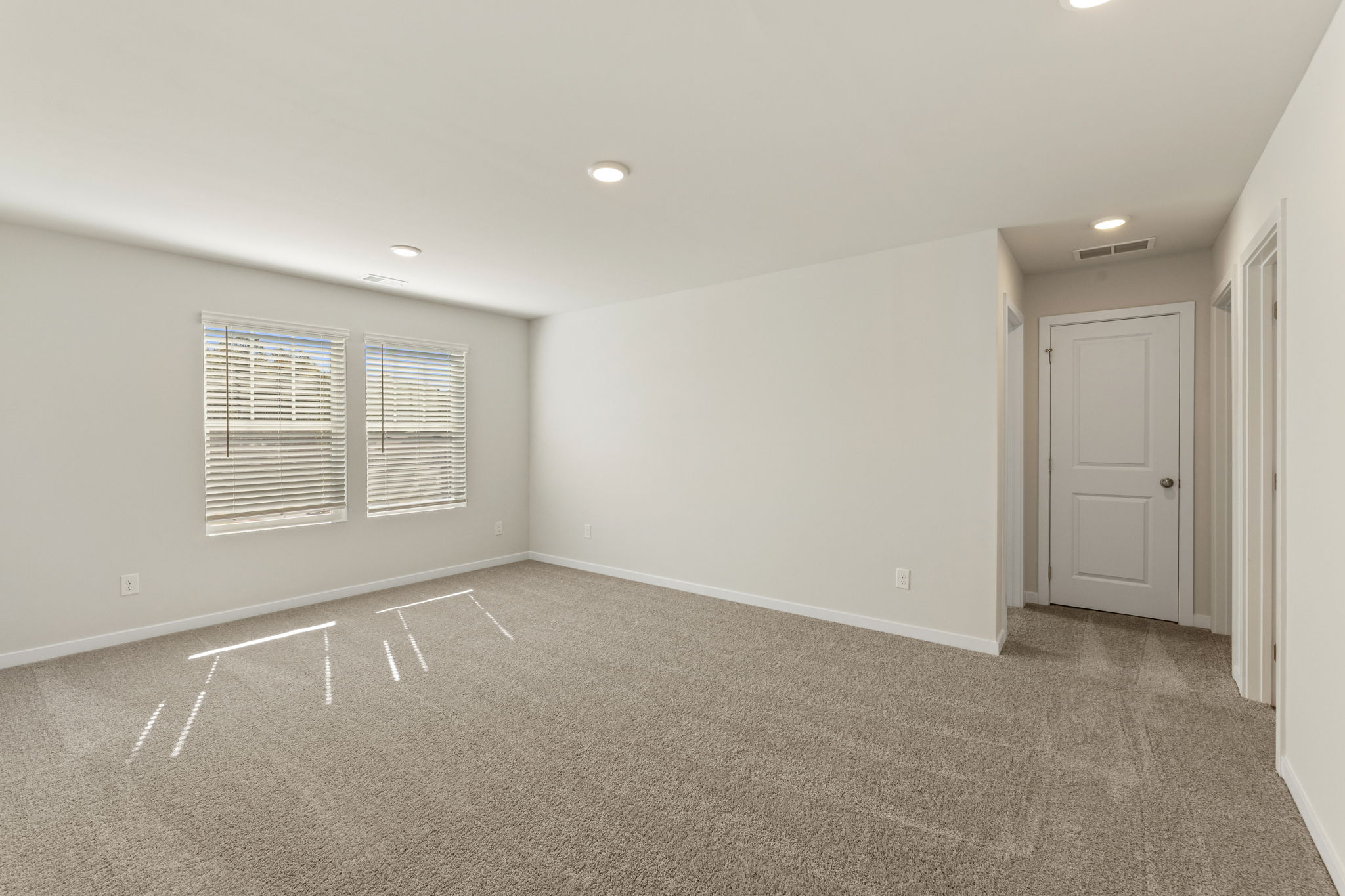 A room with white walls and a white door.