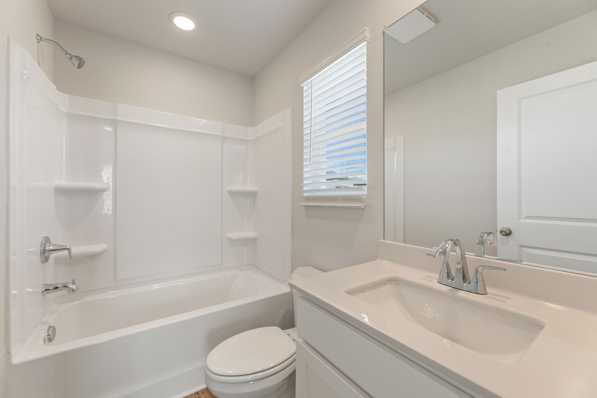 A bathroom with a tub sink and toilet.