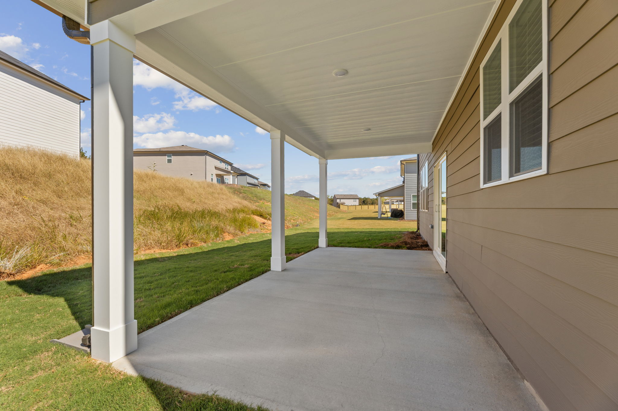 A building with a walkway and grass.
