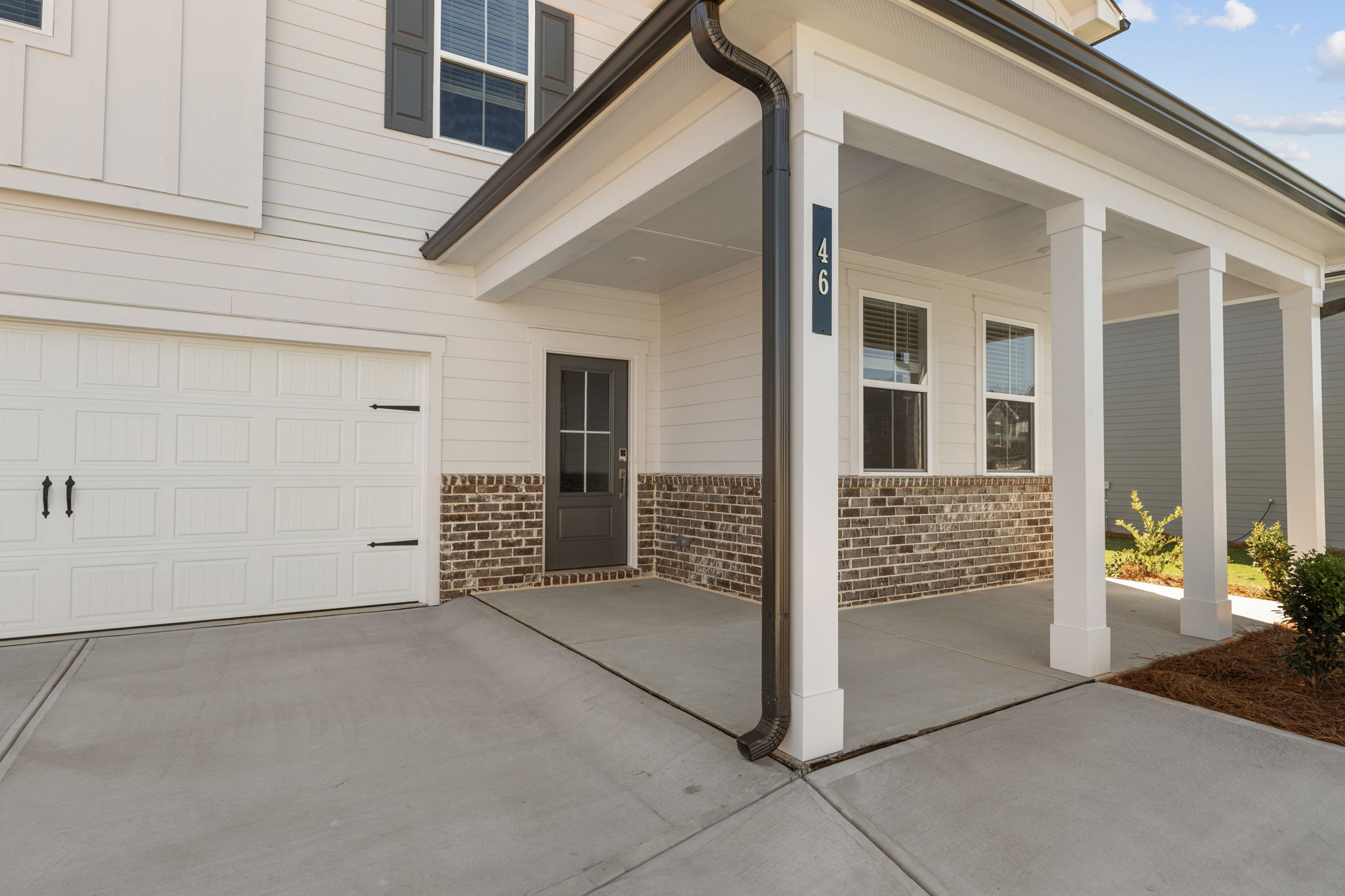 A white building with a garage.