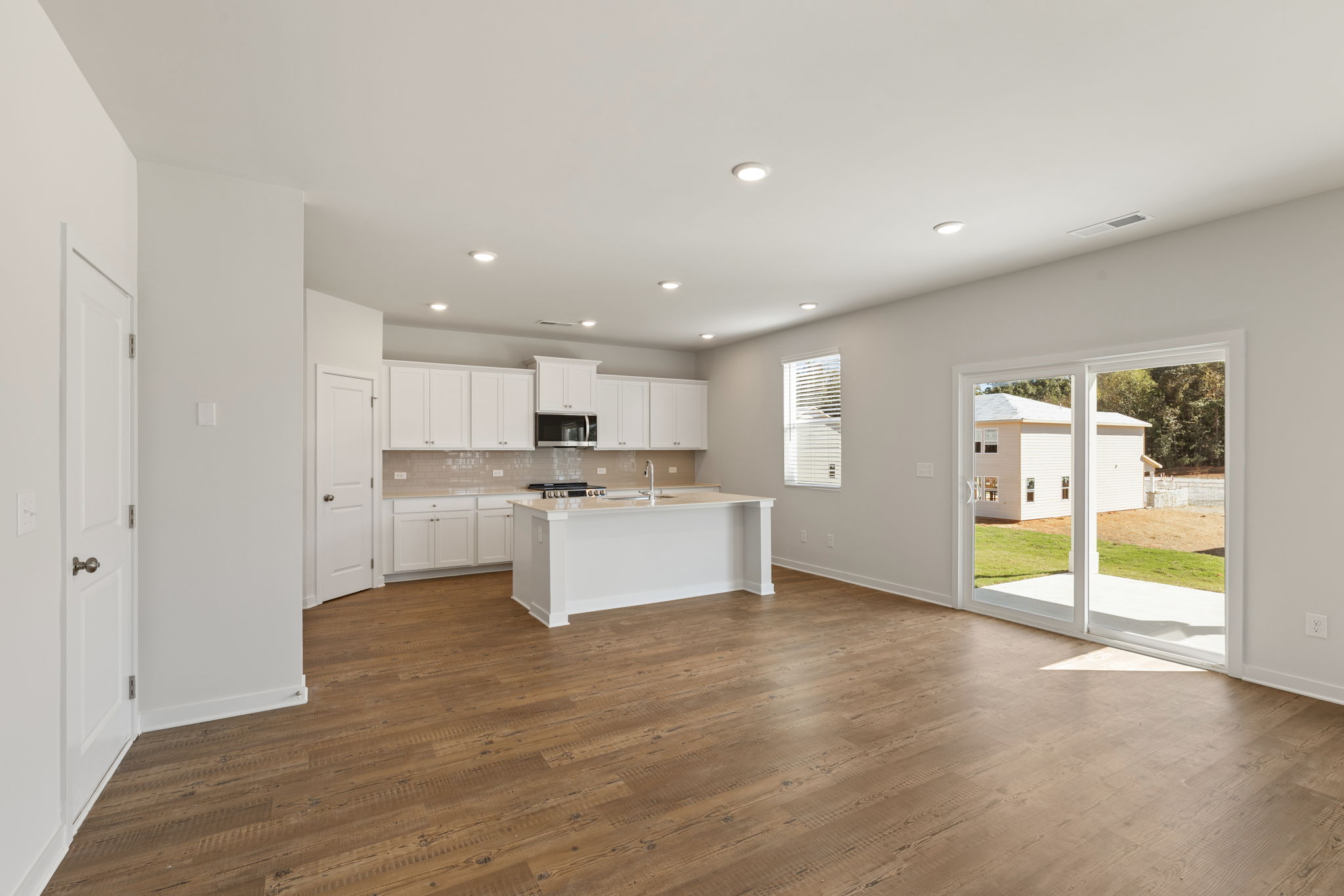 A kitchen with white cabinets.