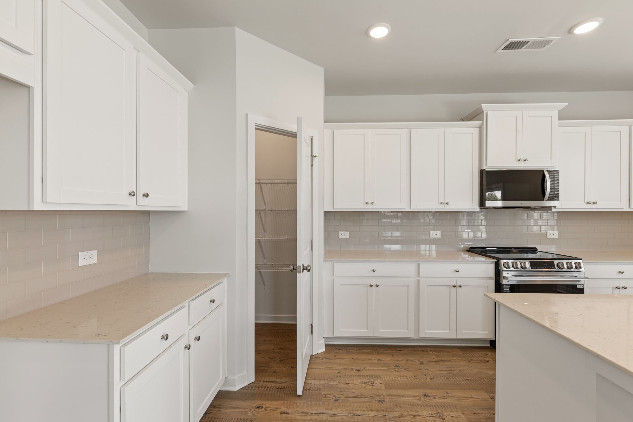 A kitchen with white cabinets.