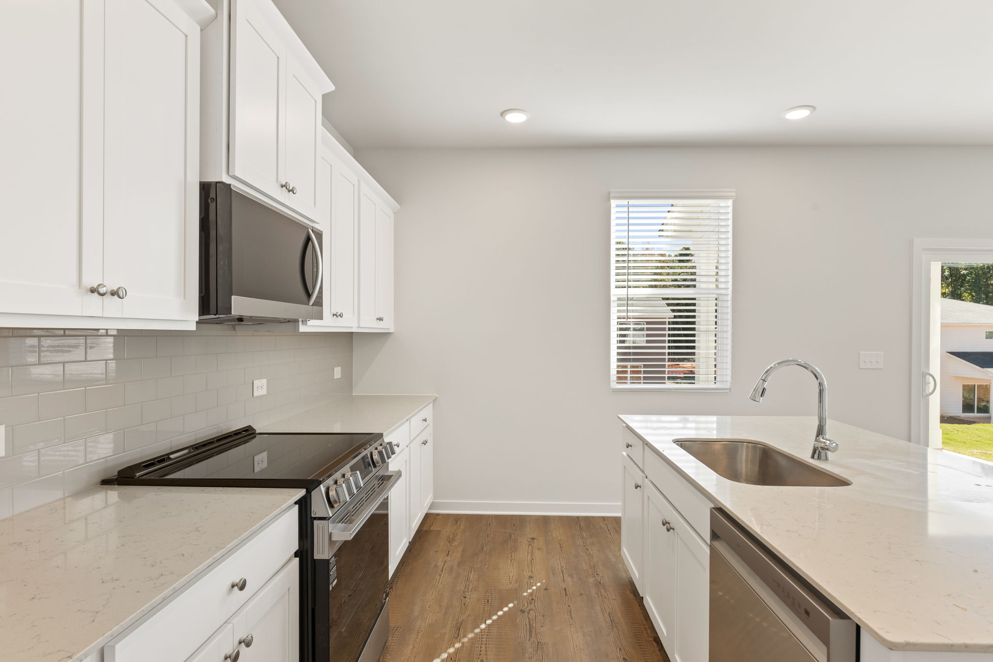 A kitchen with white cabinets.