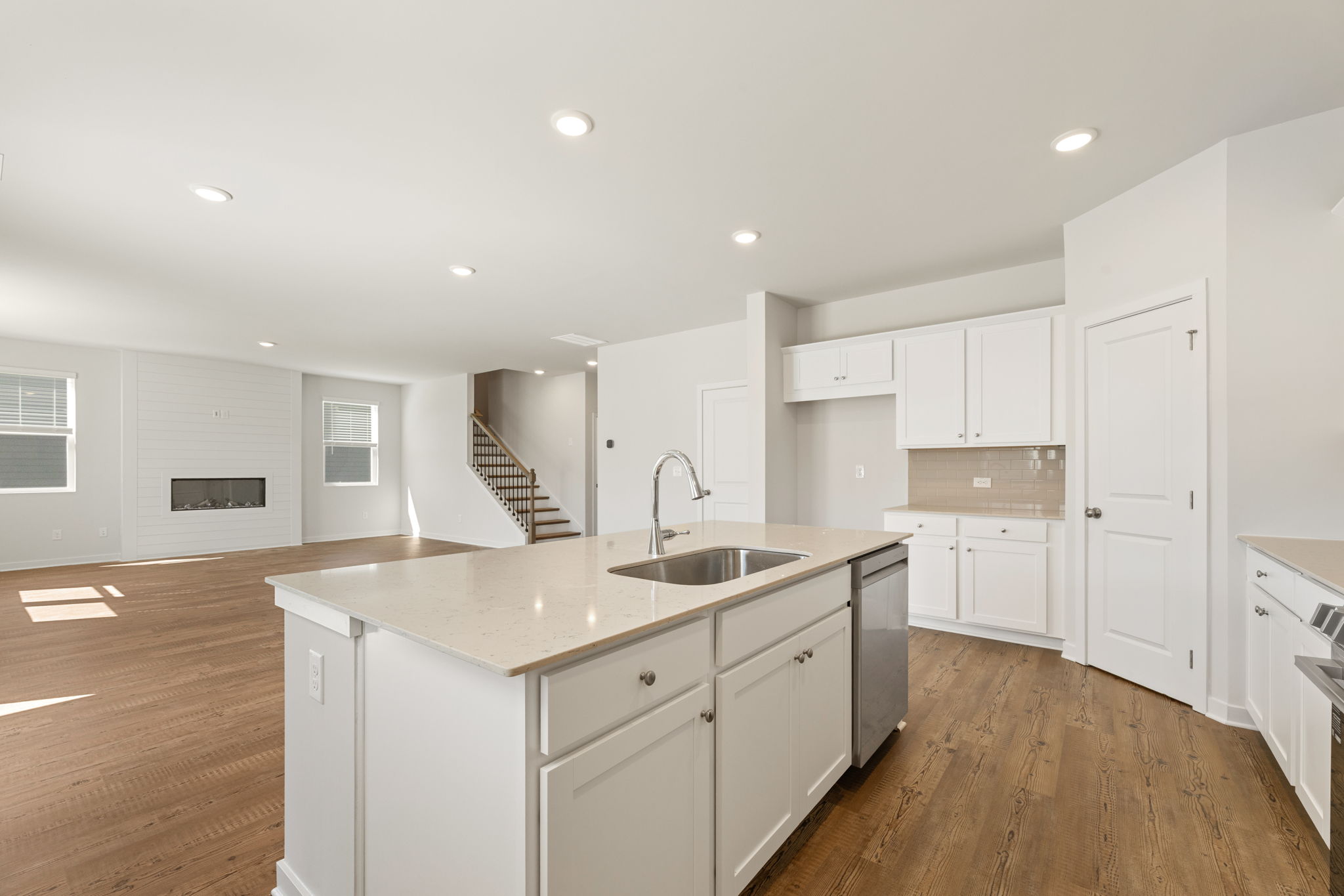 A kitchen with white cabinets.