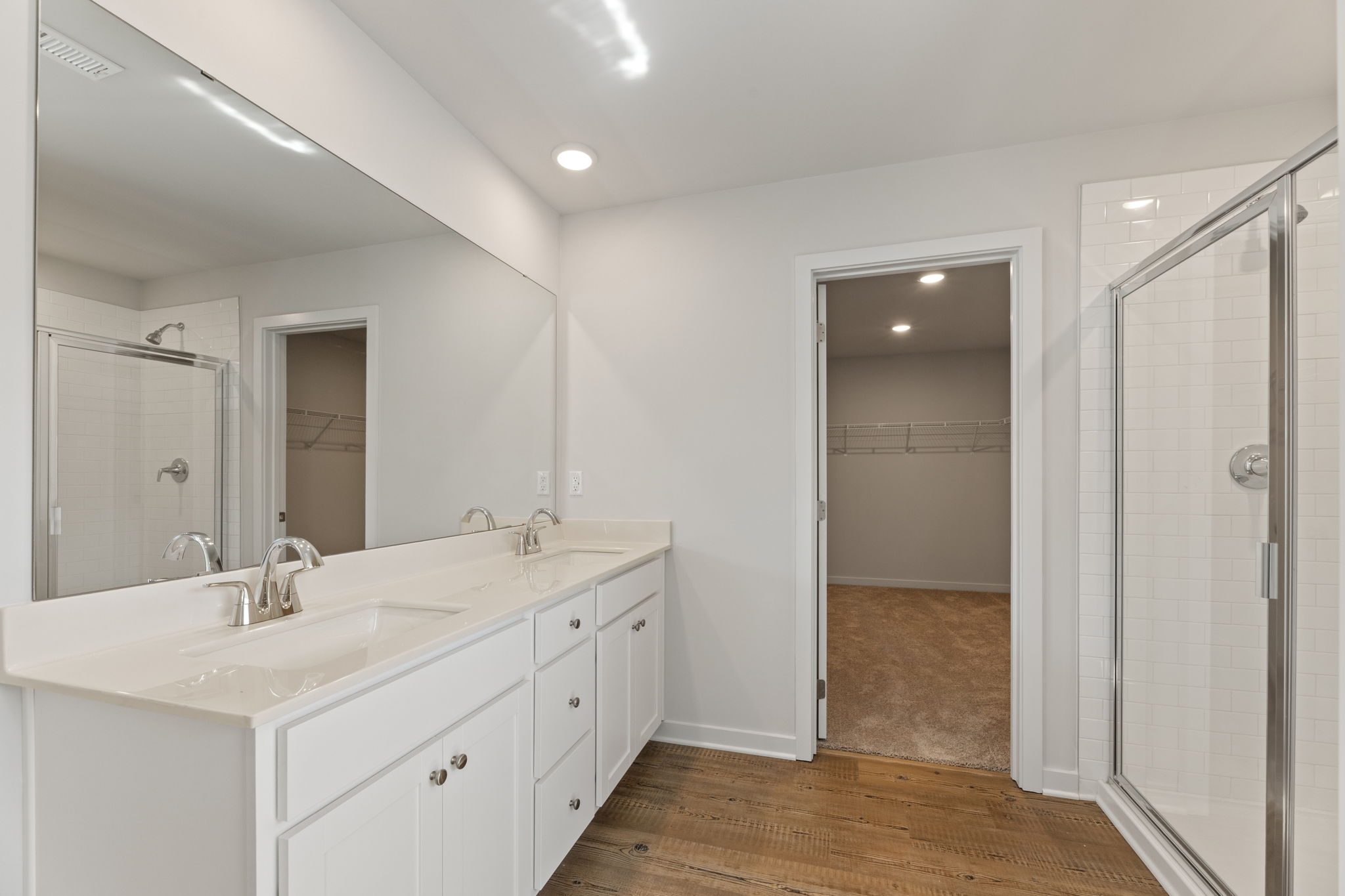 A bathroom with a shower and sink.