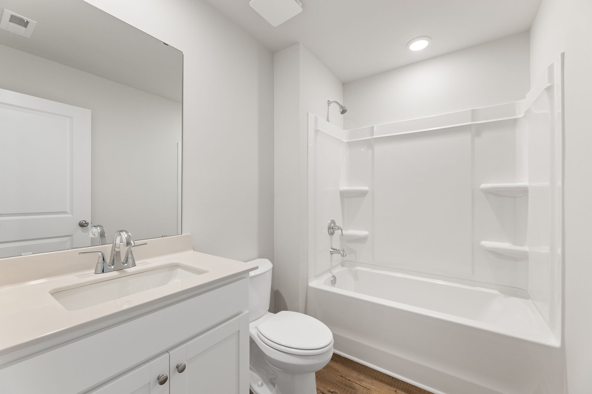 A bathroom with a tub toilet and sink.