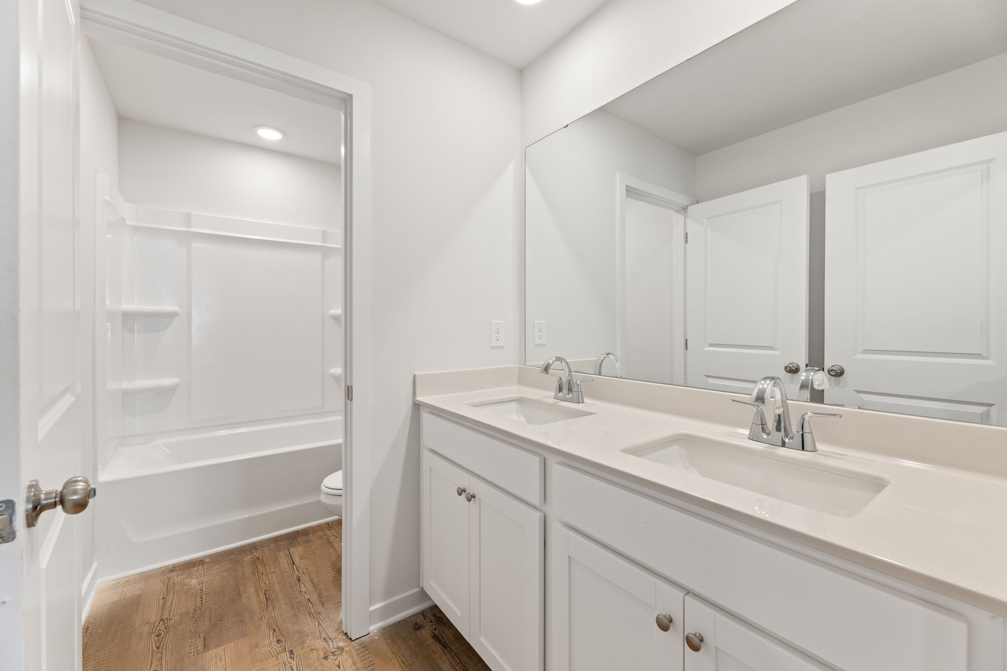 A bathroom with a tub sink and a shower.