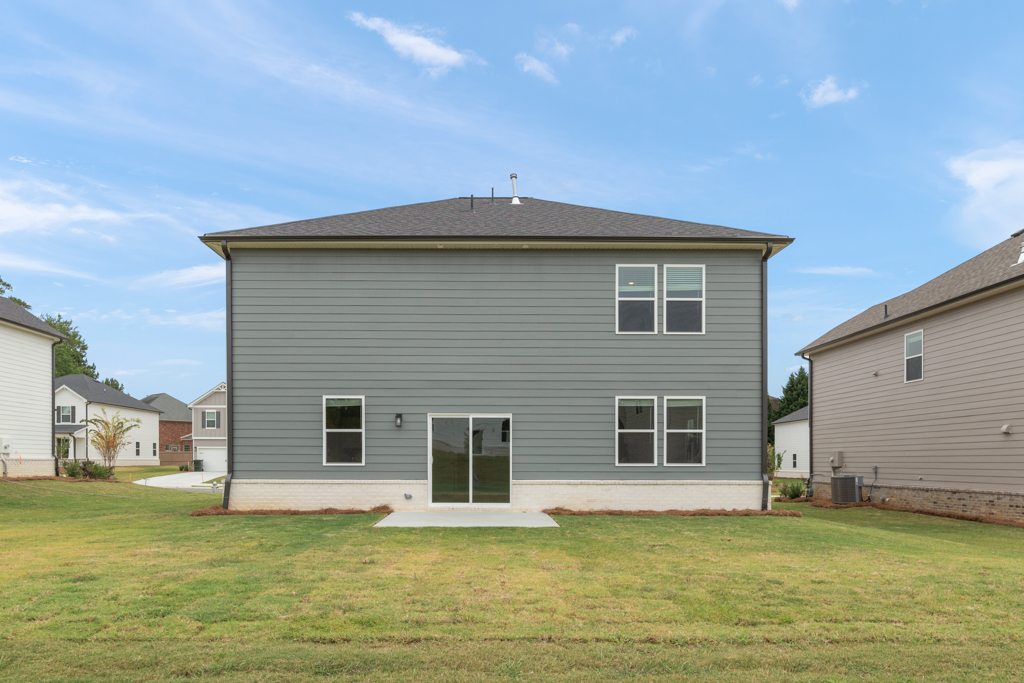 A grey house with a garage.