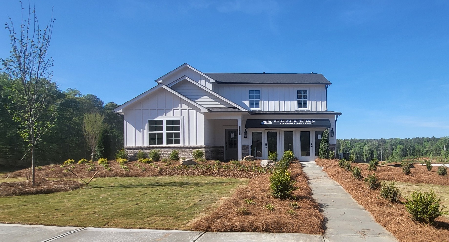 A white building with a sign on it.