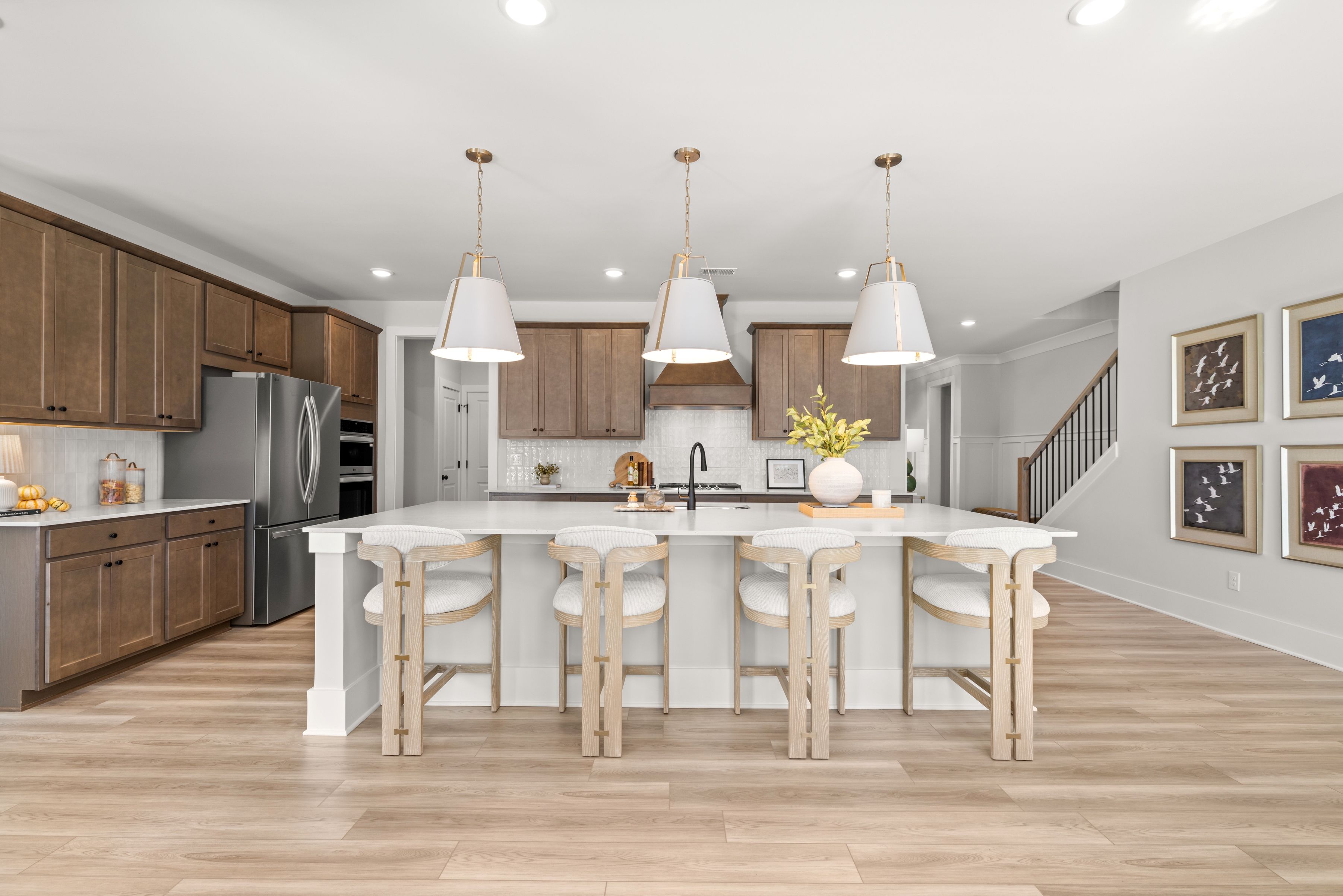 A kitchen with a bar and stools.