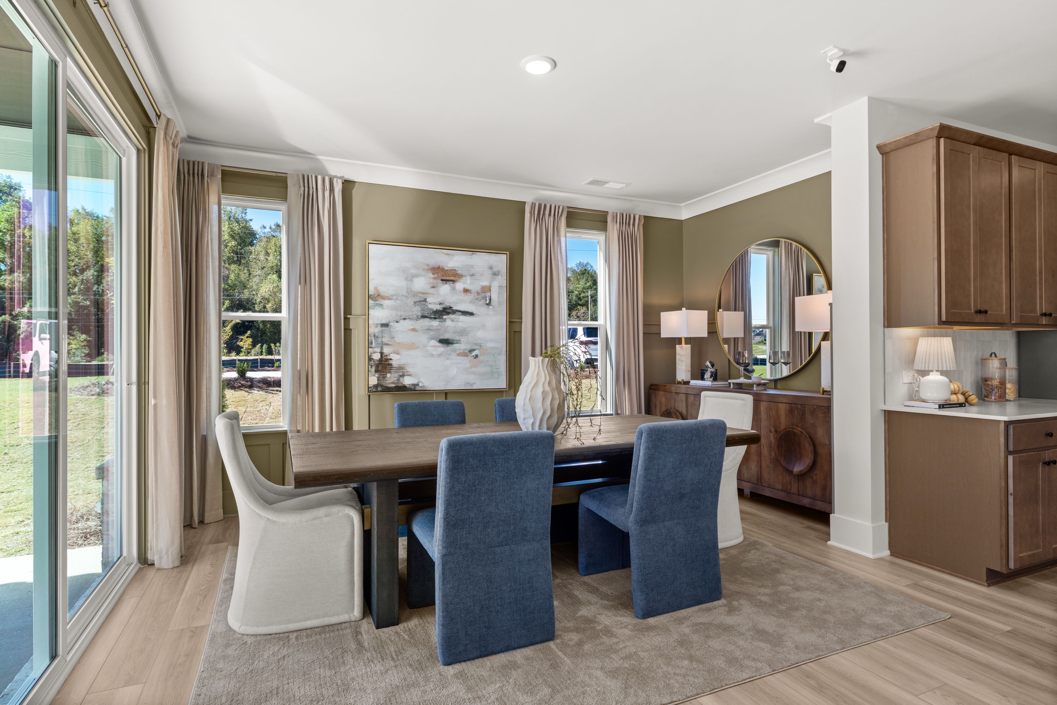 A dining room with a large table.
