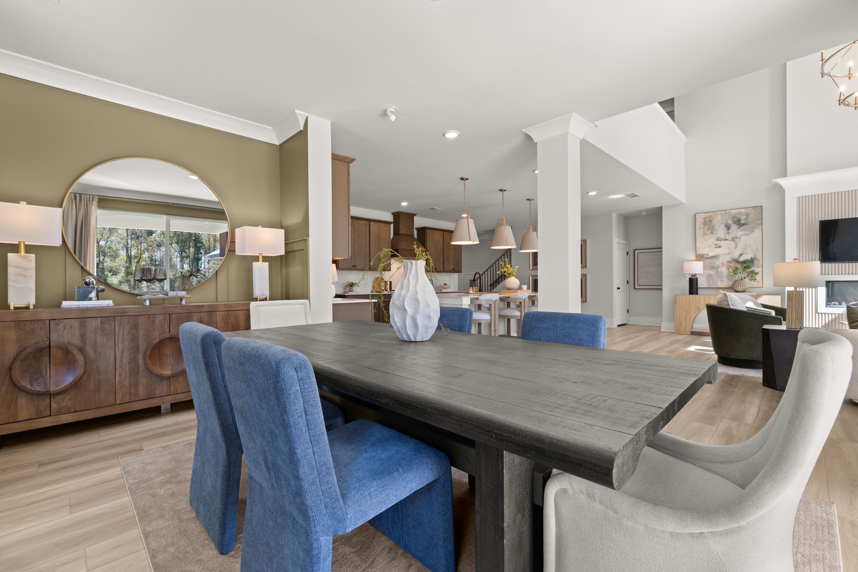 A large living room with a large dining table and chairs.