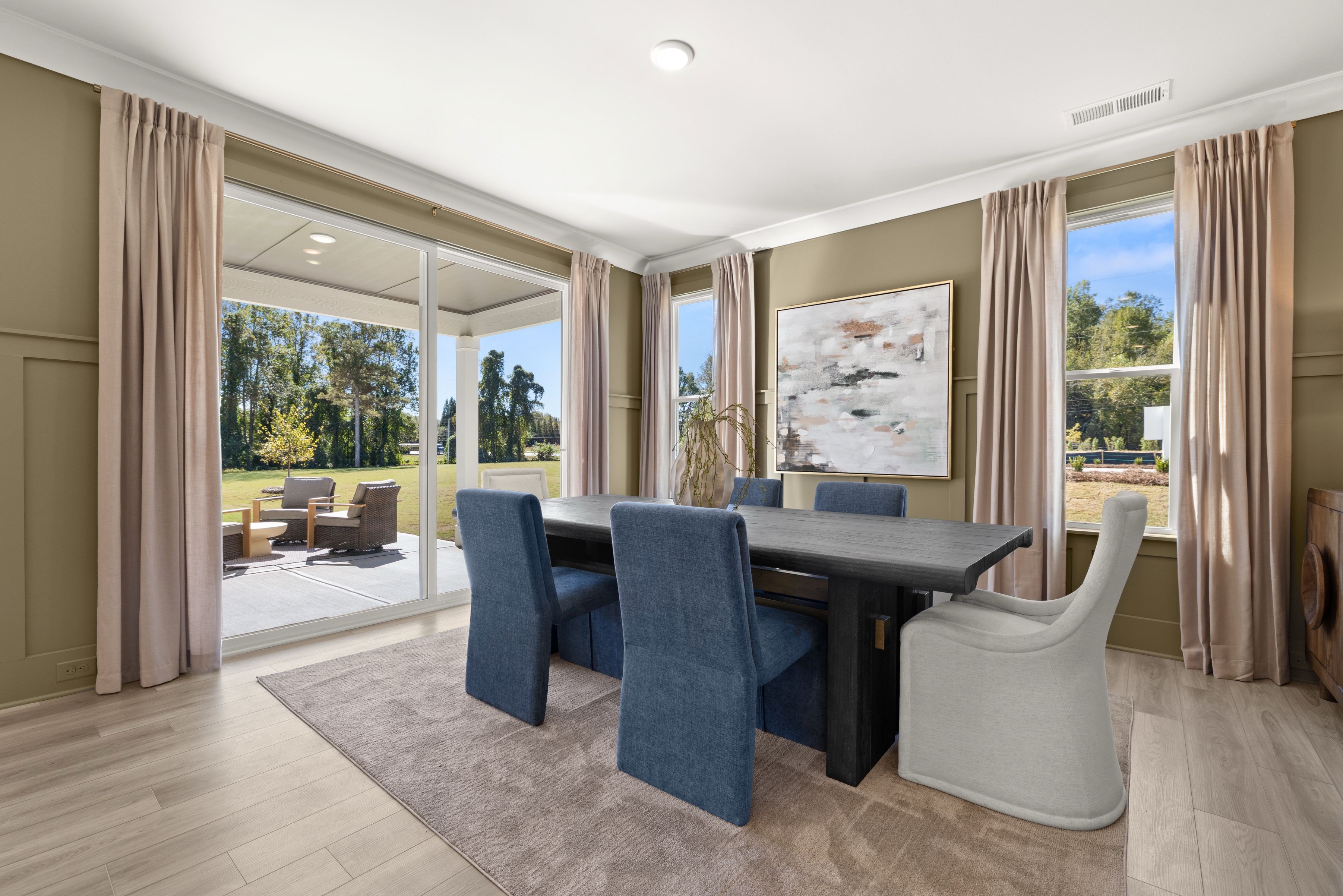A living room with a large table and chairs.