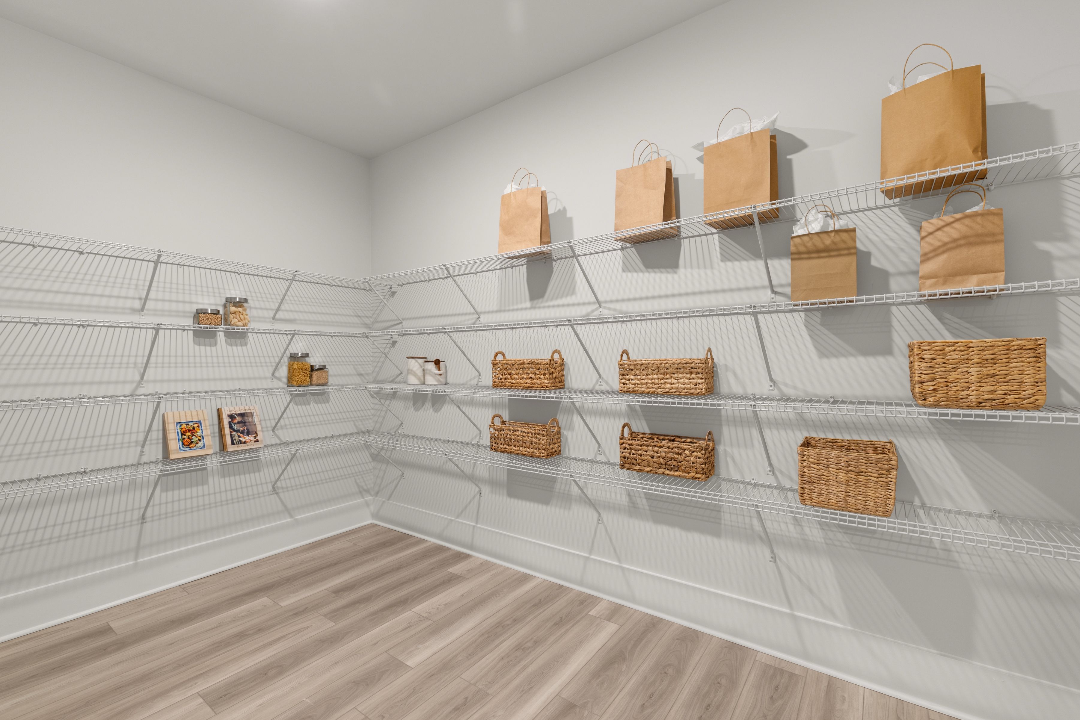 A white shelf with baskets and bags.