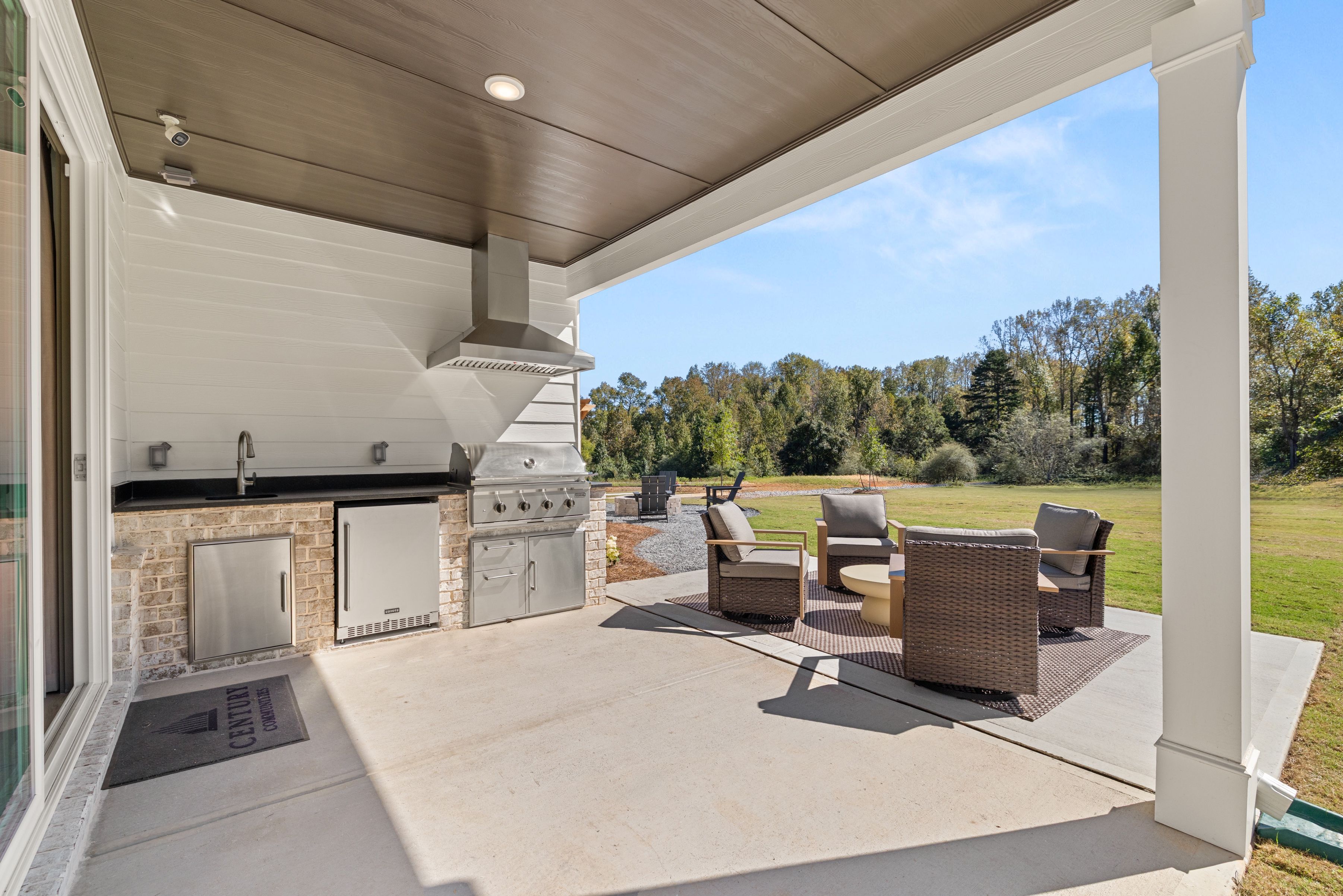 A patio with chairs and a table.