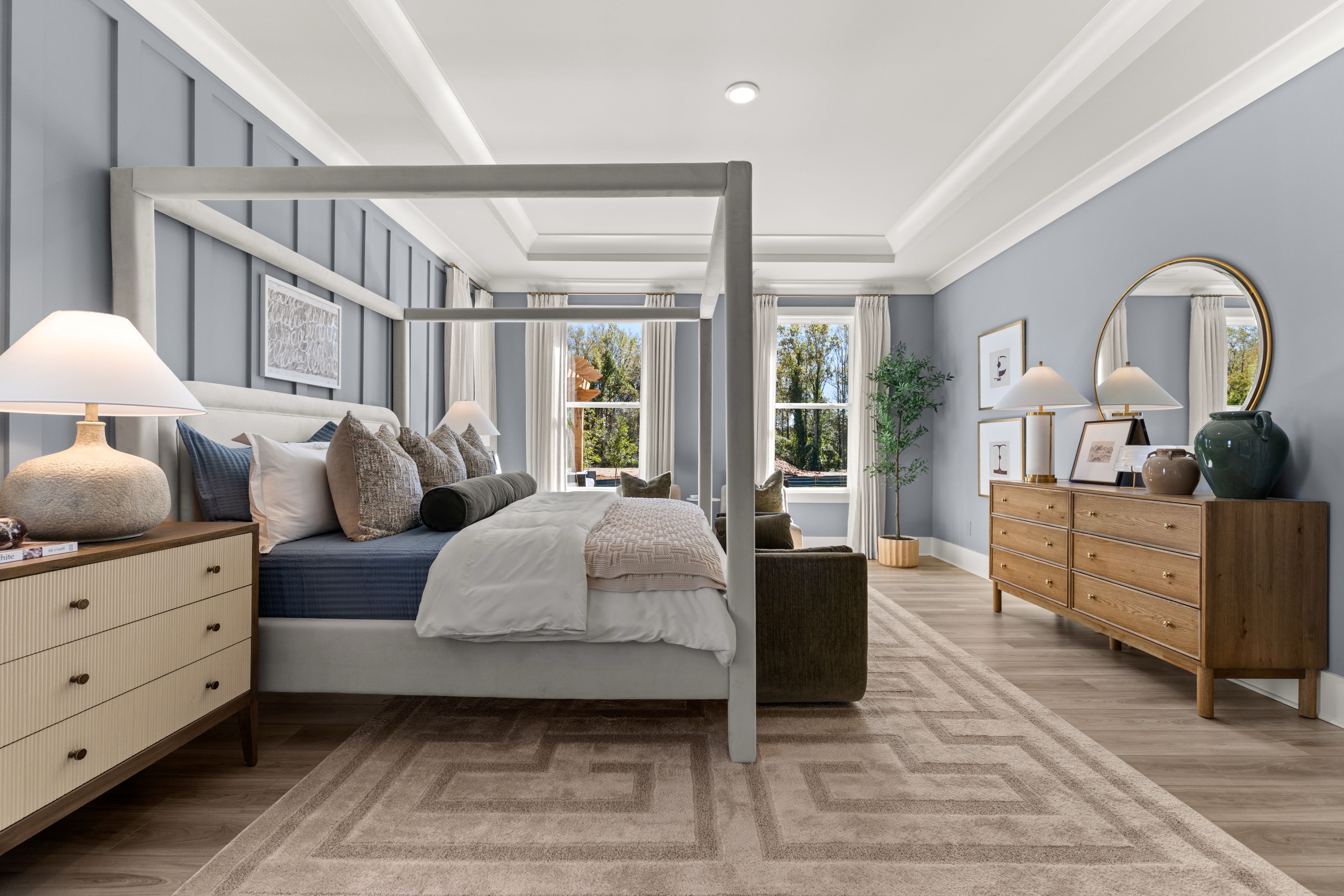 A bedroom with a large bed and a large mirror.