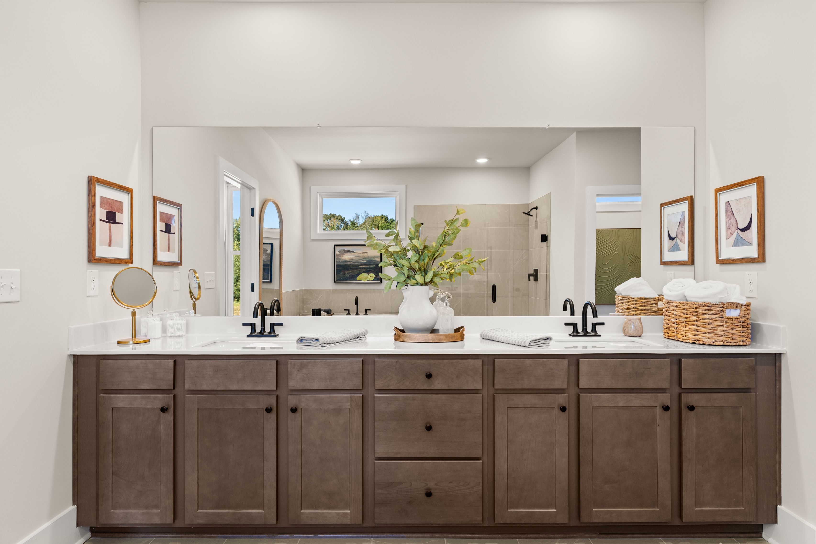 A bathroom with a large mirror.
