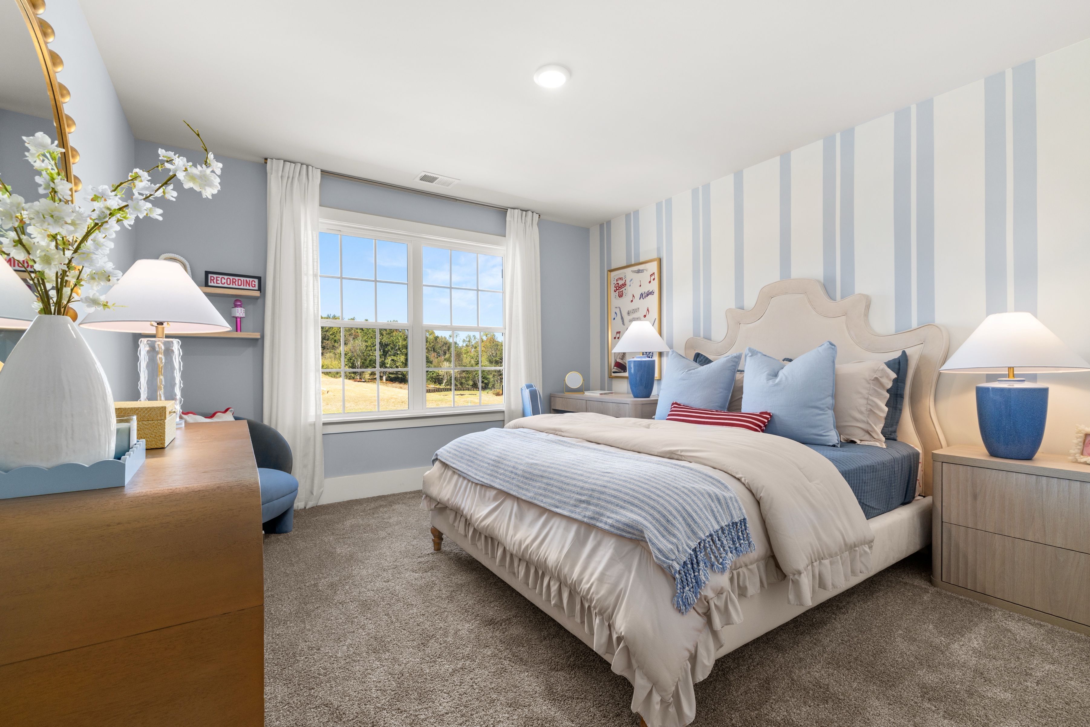 A bedroom with a bed and lamps.