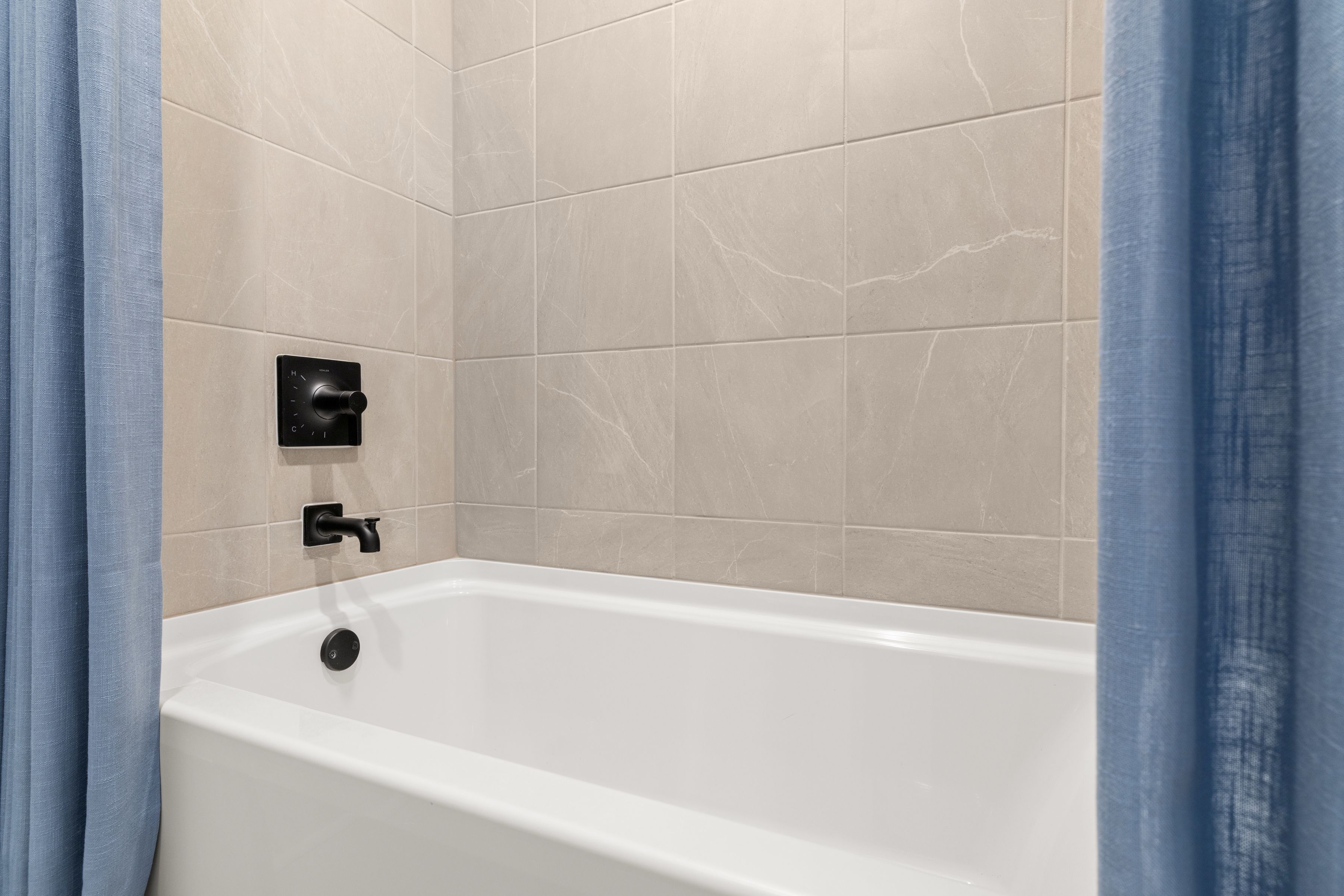 A bathtub in a bathroom.