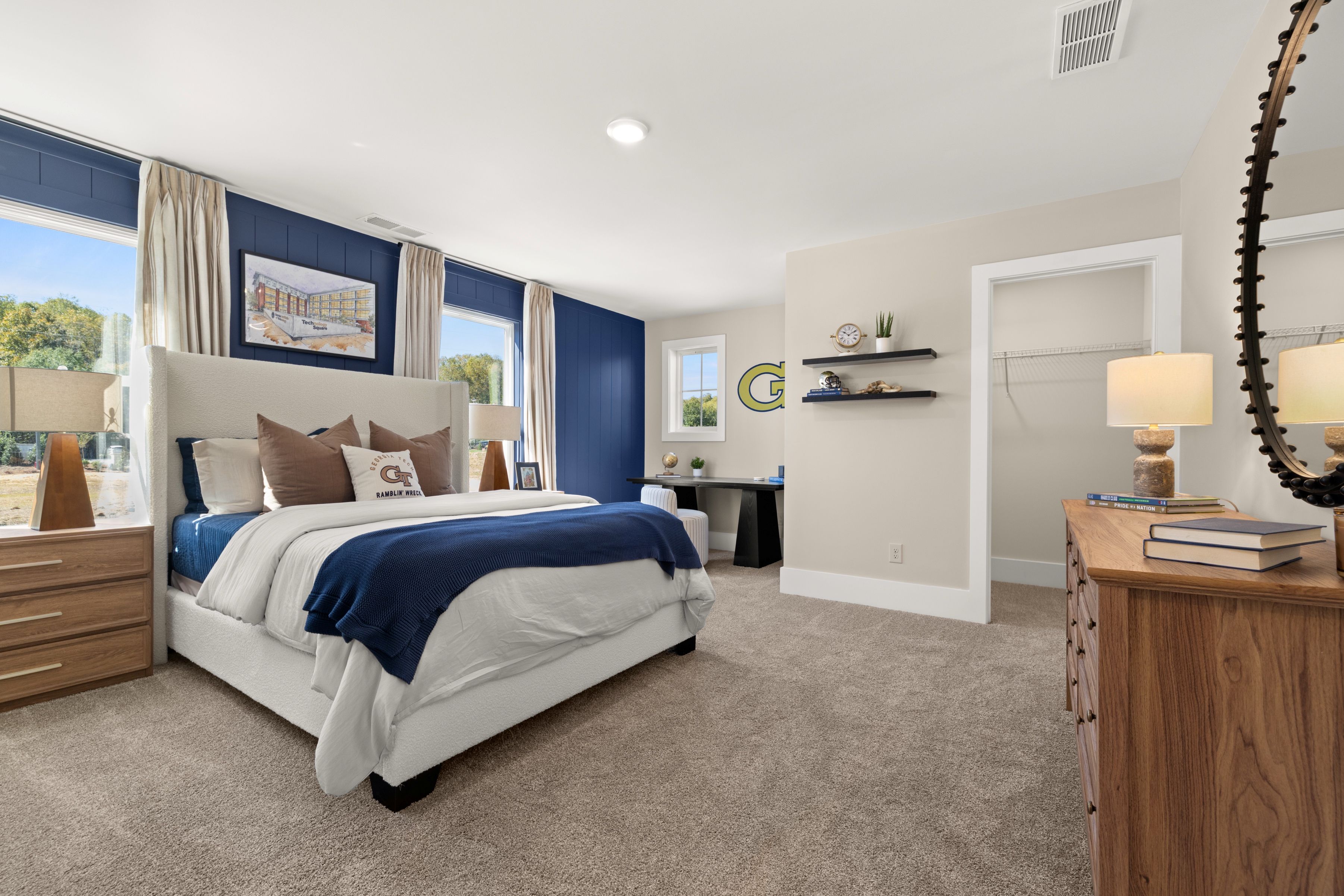 A bedroom with a bed and a mirror.