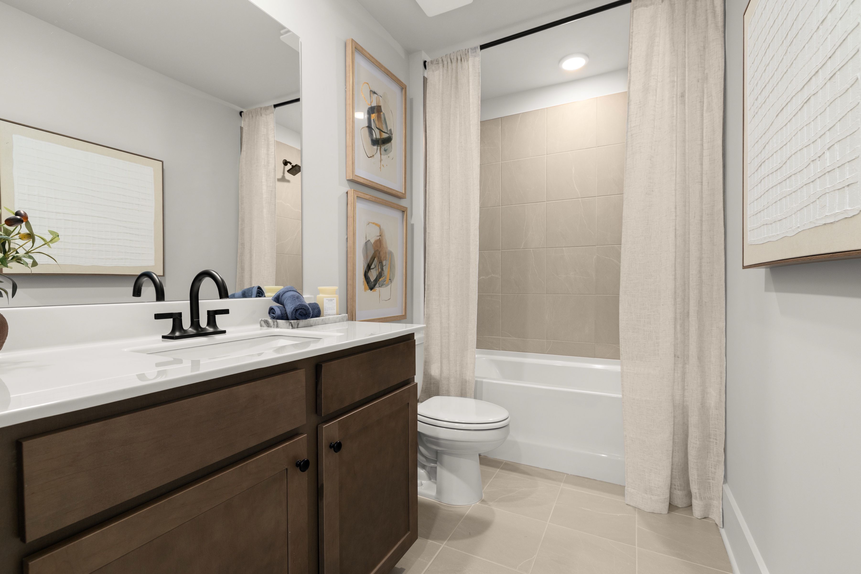 A bathroom with a tub toilet and sink.