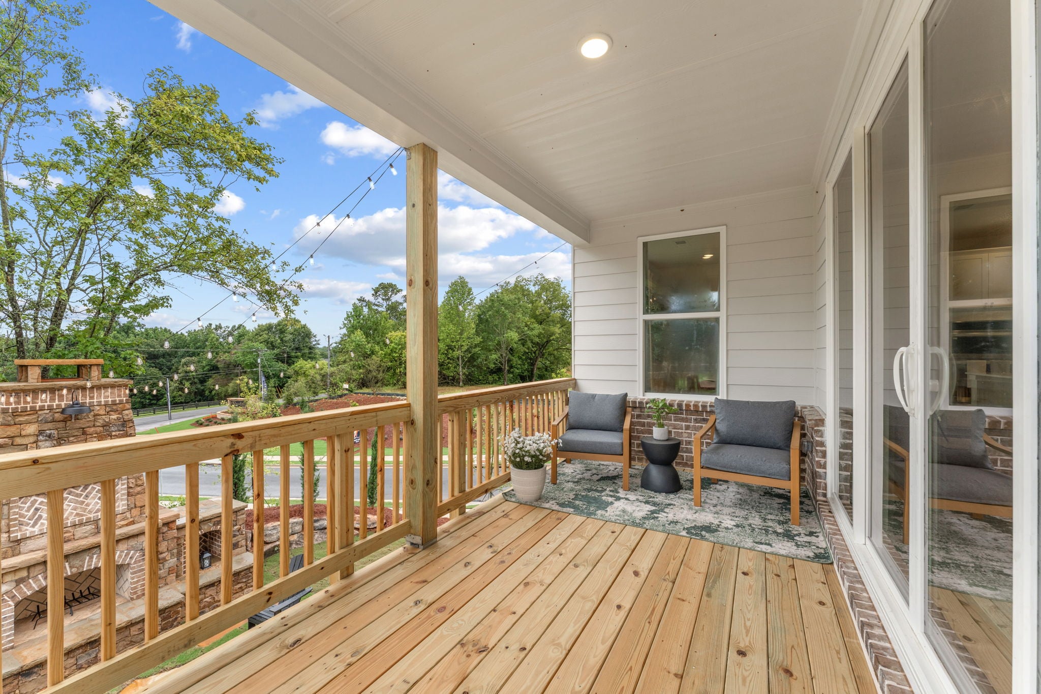 A deck with a chair and a table on it.