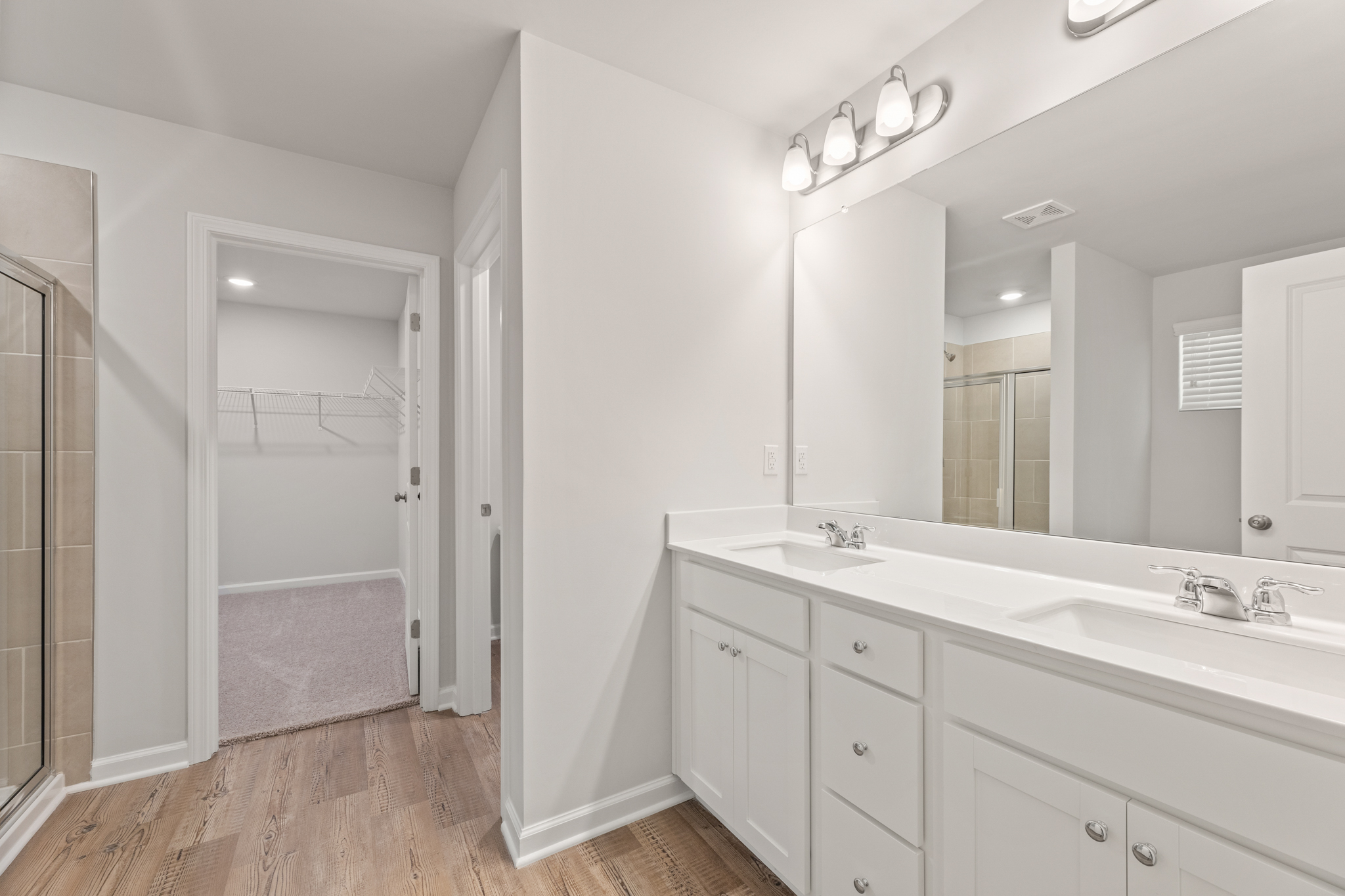 A bathroom with a shower and sink.