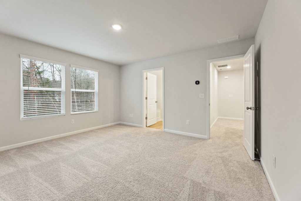 A room with white walls and a carpeted floor.