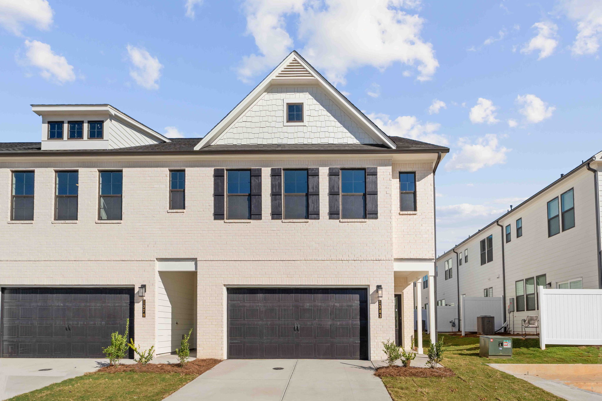 A white building with a garage.
