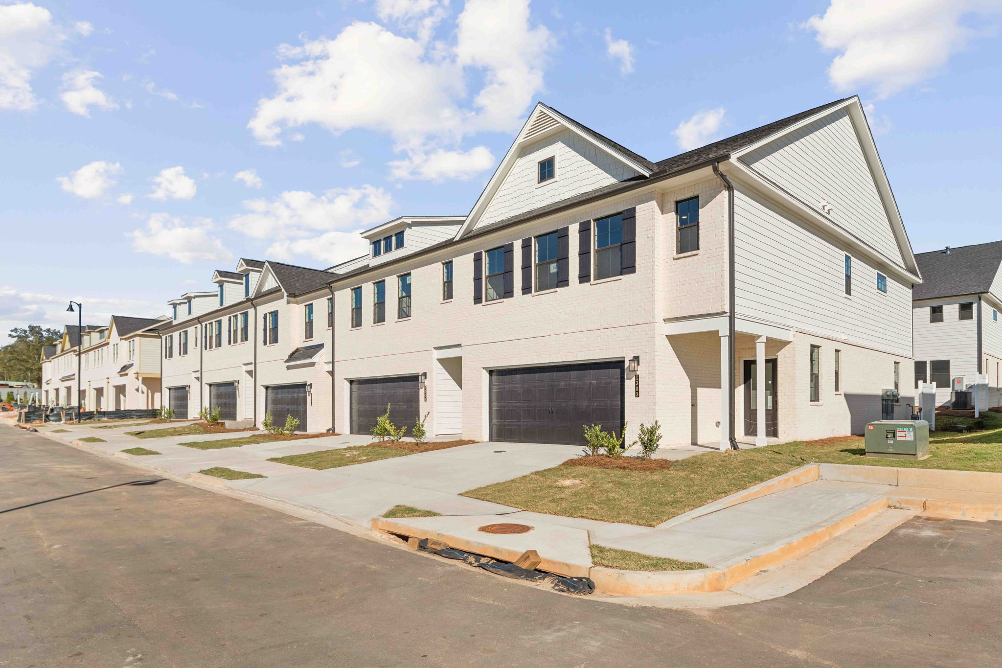 A white building with a driveway.