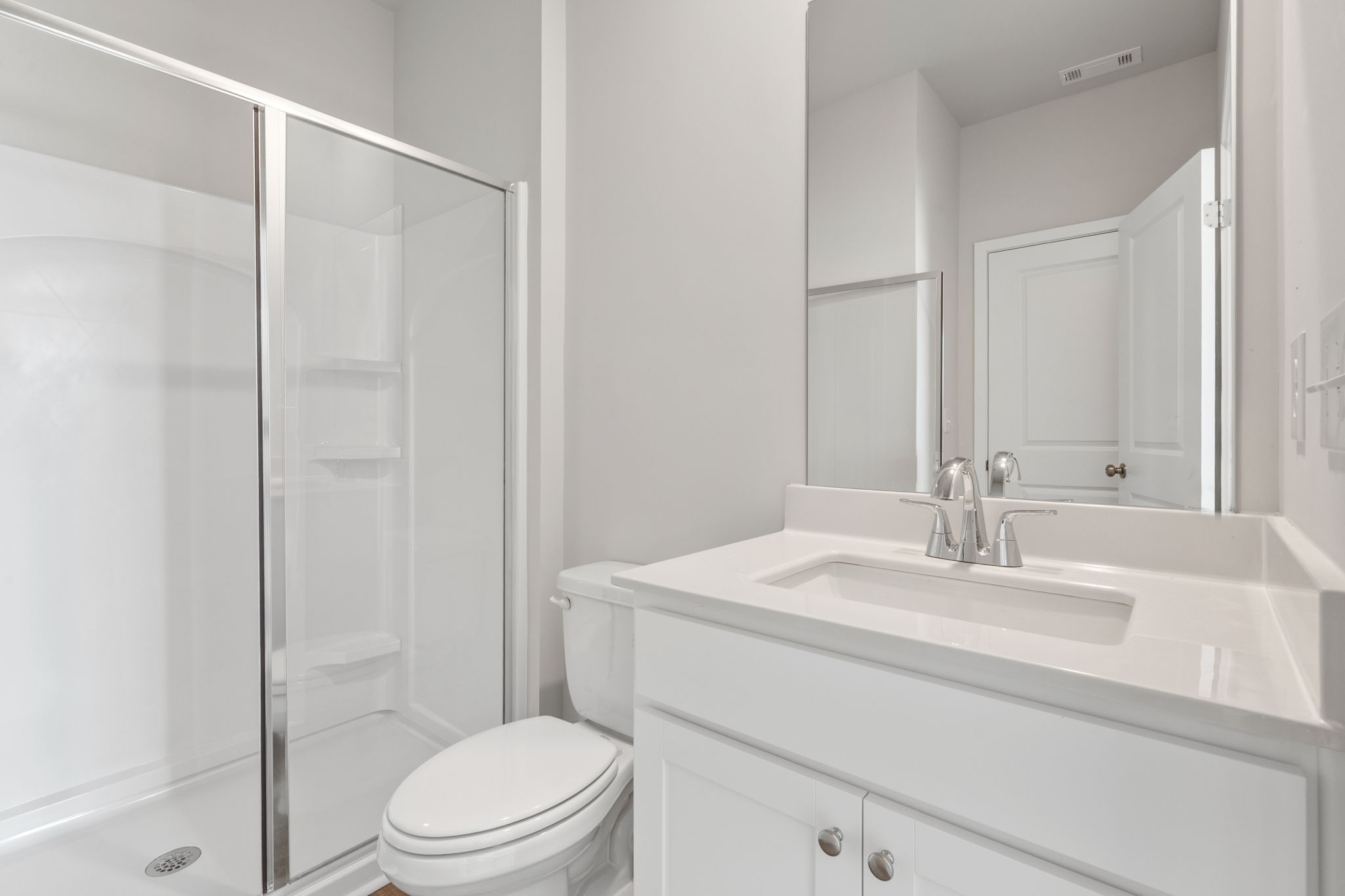 A bathroom with a glass shower.