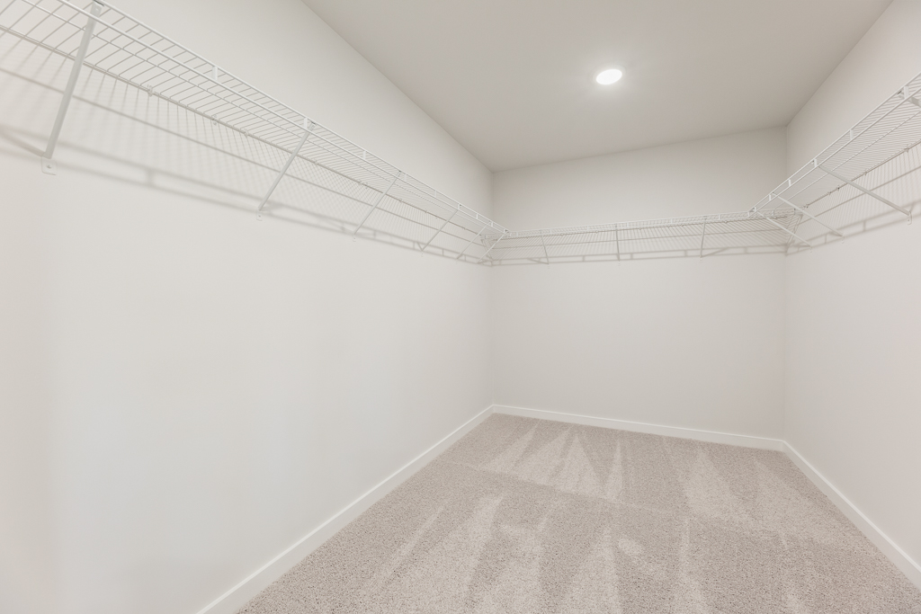 A white hallway with a white wall.