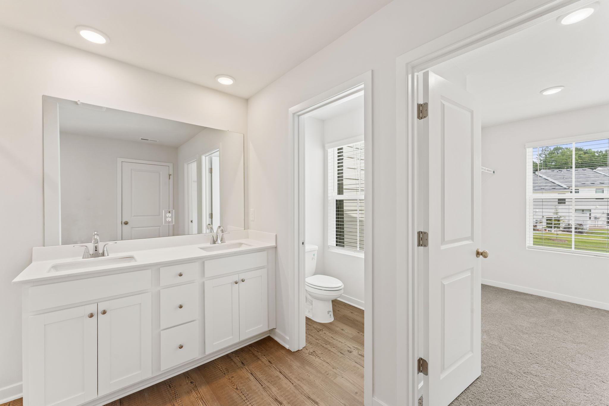 A bathroom with white cabinets.