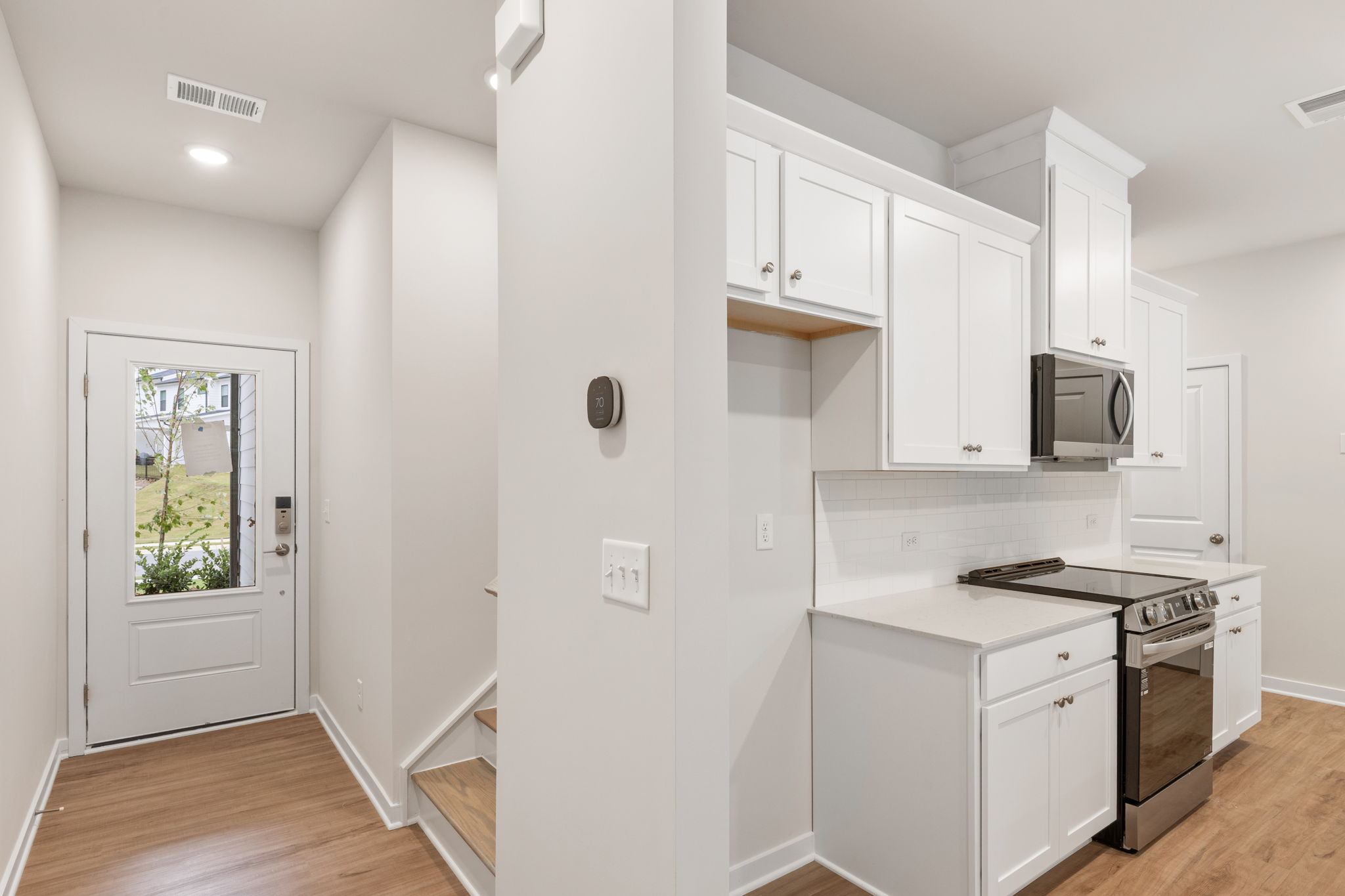 A kitchen with white cabinets.