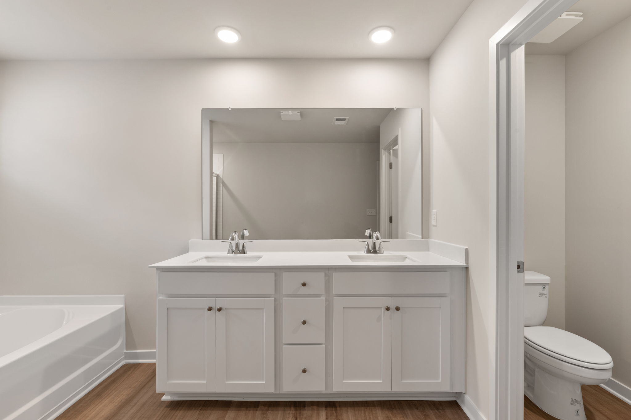 A bathroom with a tub sink and toilet.