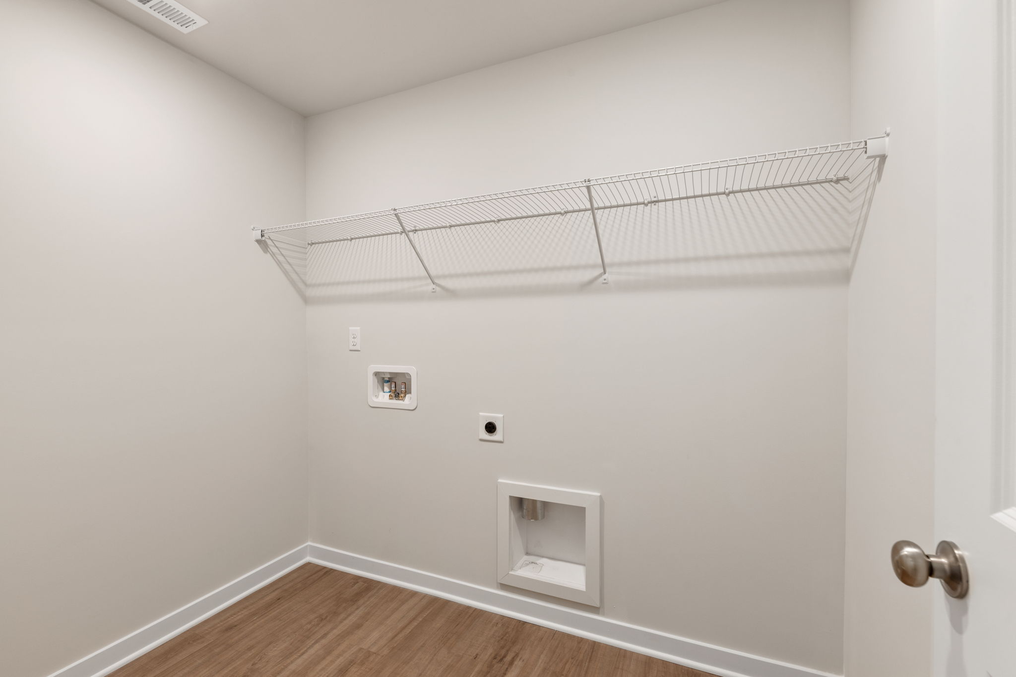 A white room with a vent.