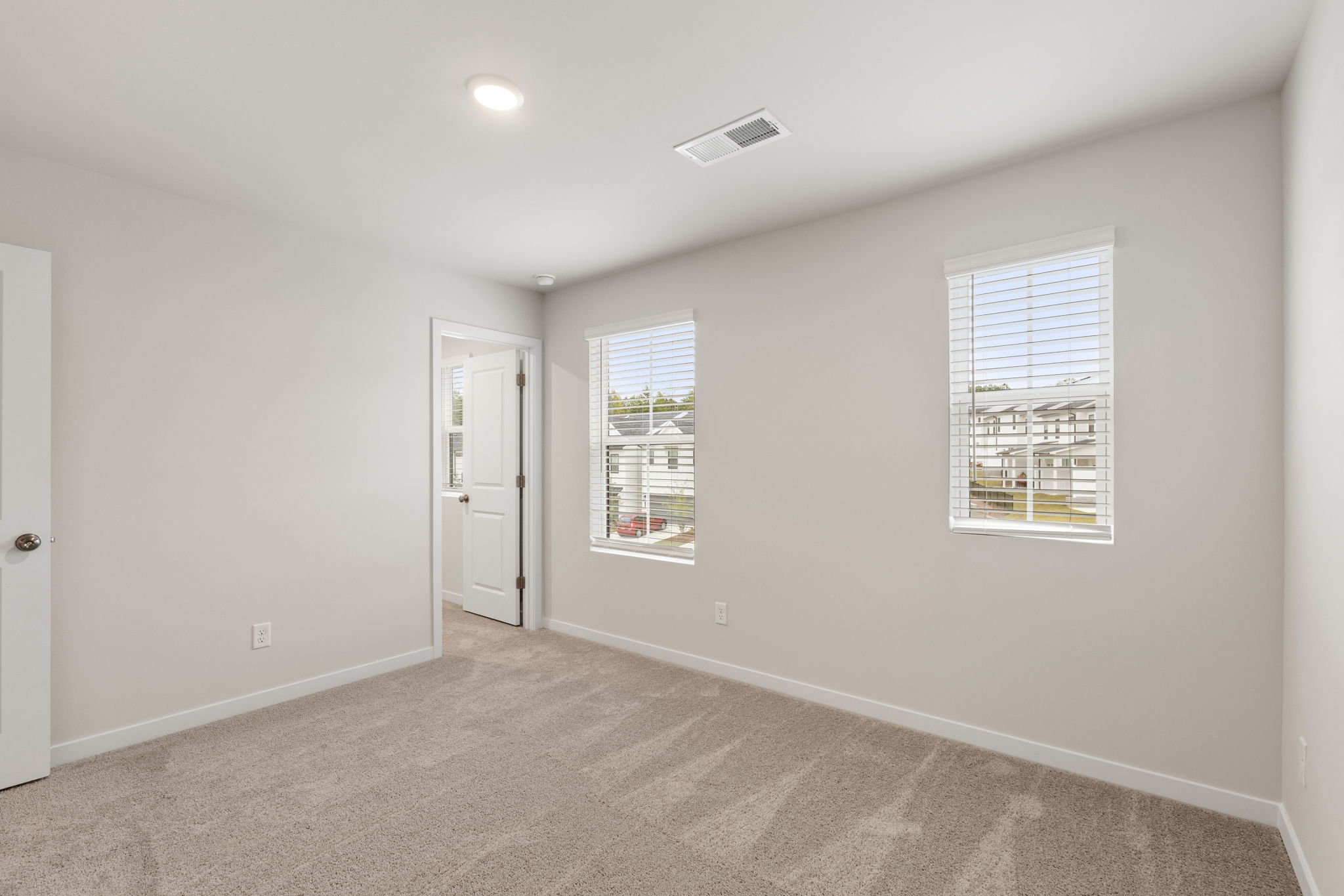 A room with a door and windows.
