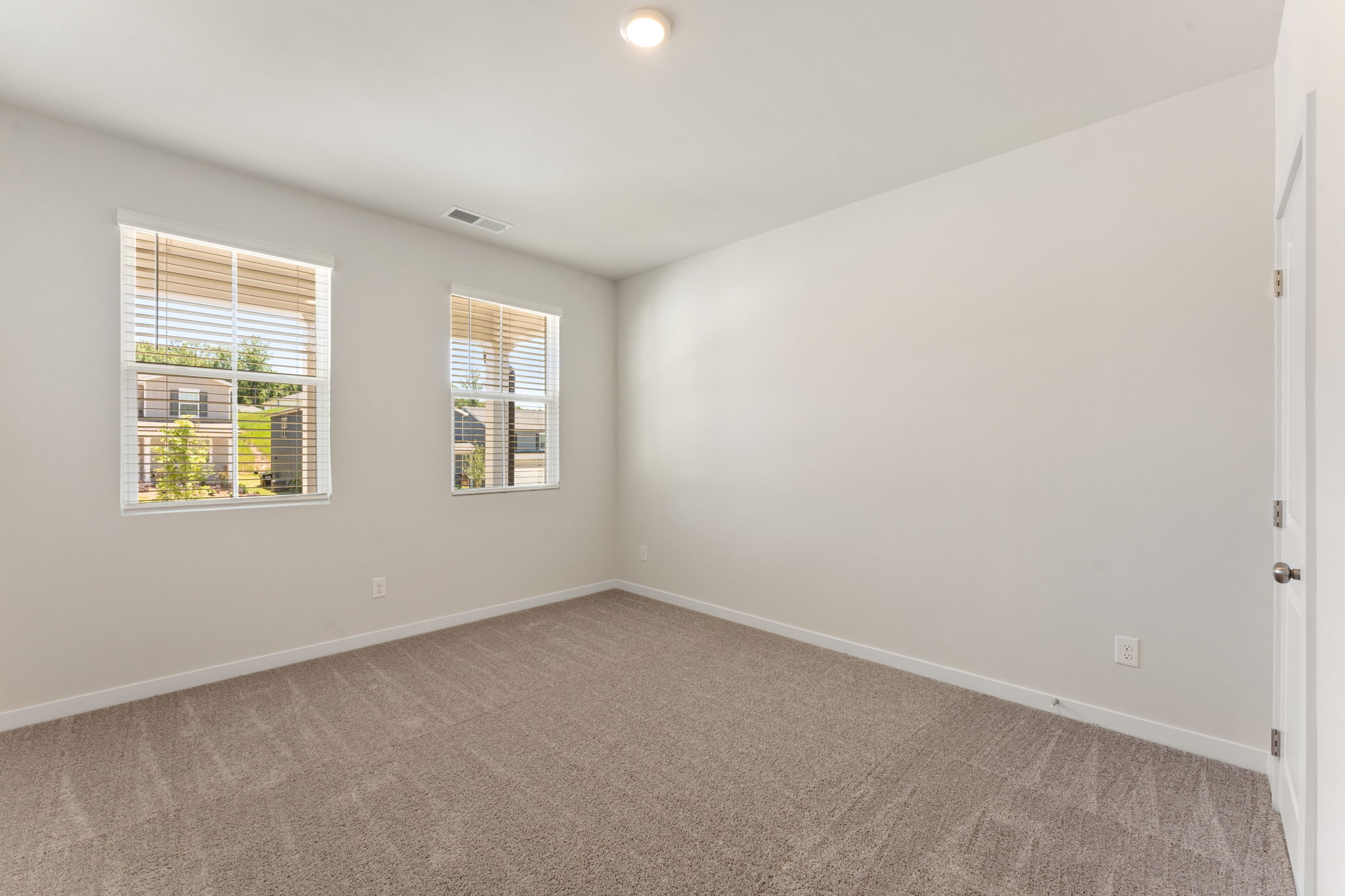 A room with a window and a carpet.
