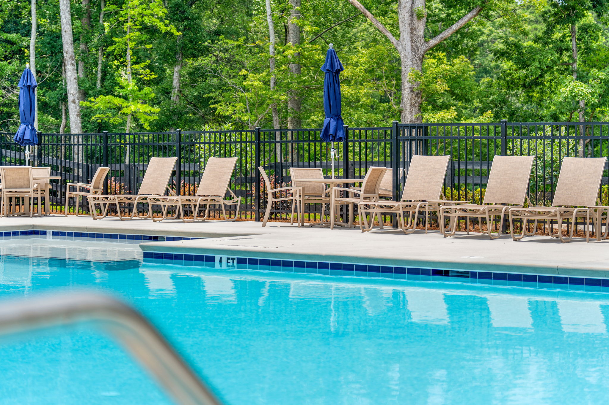 A pool with chairs around it.