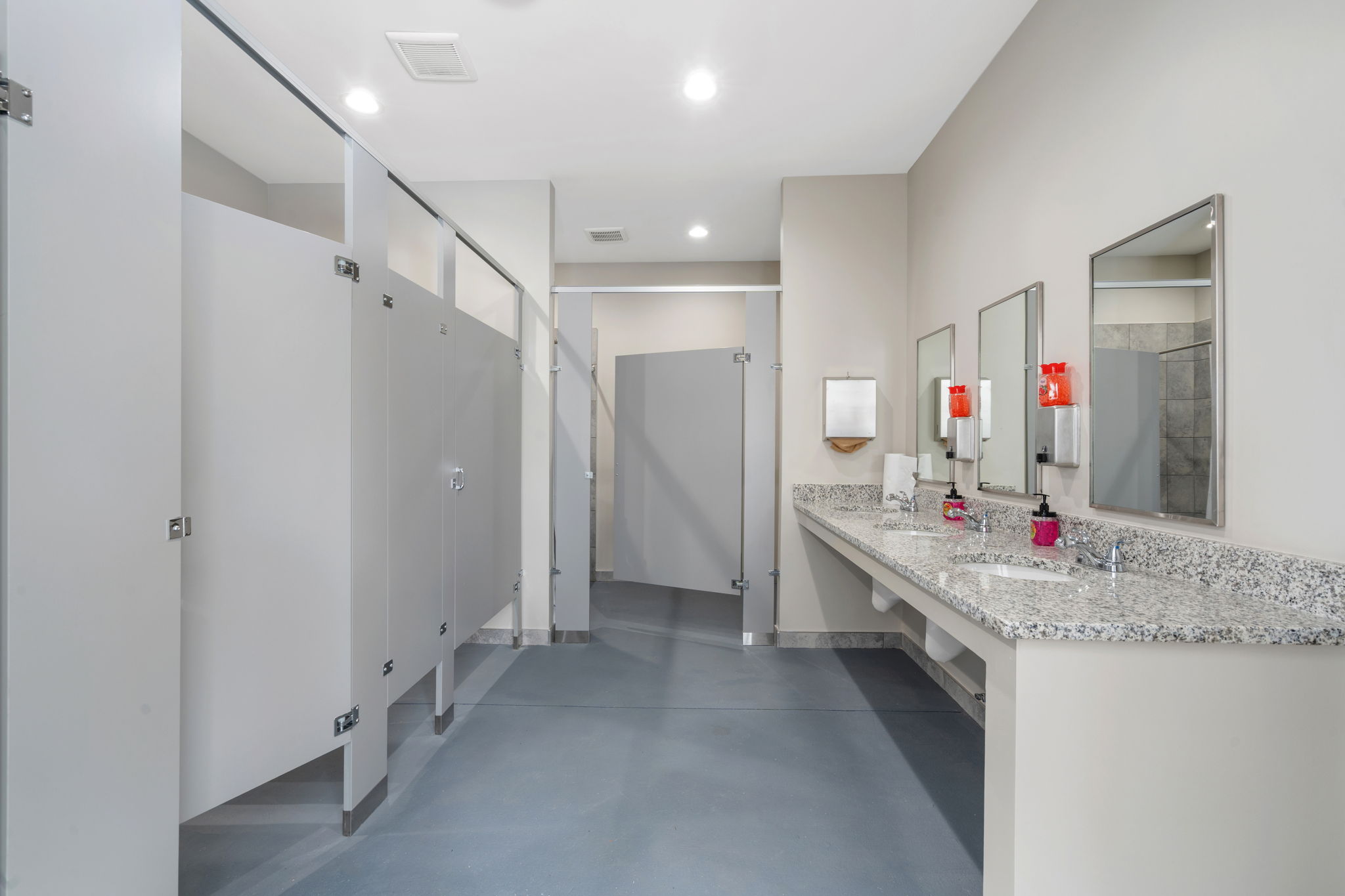 A bathroom with a countertop sink and mirrors.