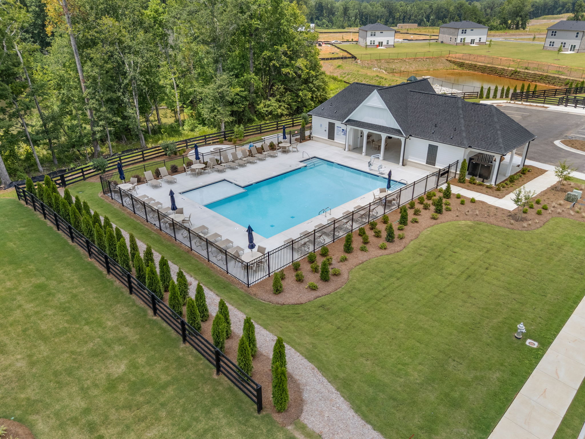 A swimming pool with a building in the background.