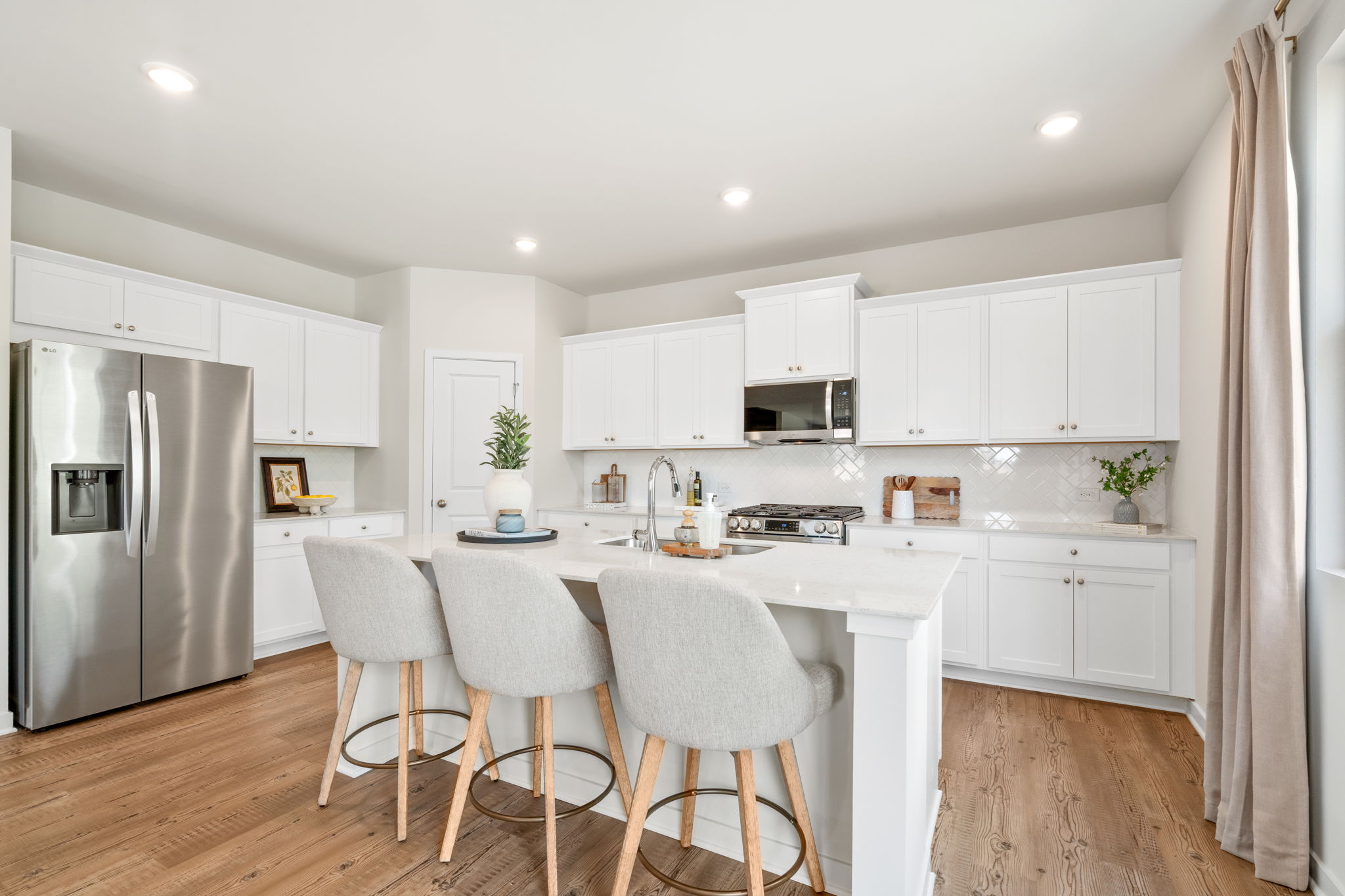 A kitchen with white cabinets.