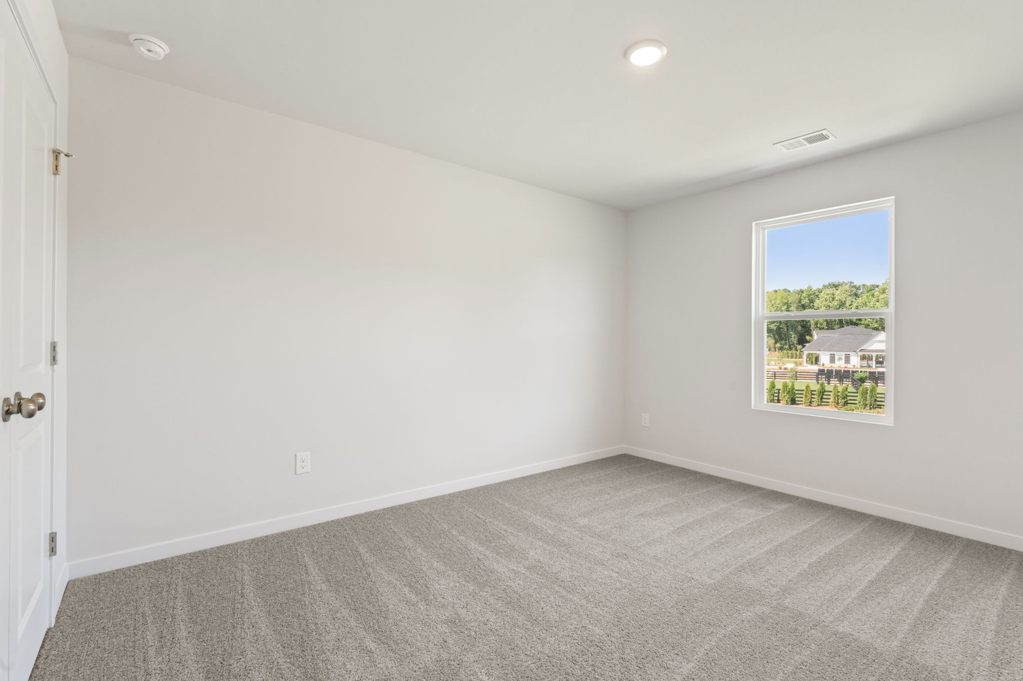 A room with a window and a door.